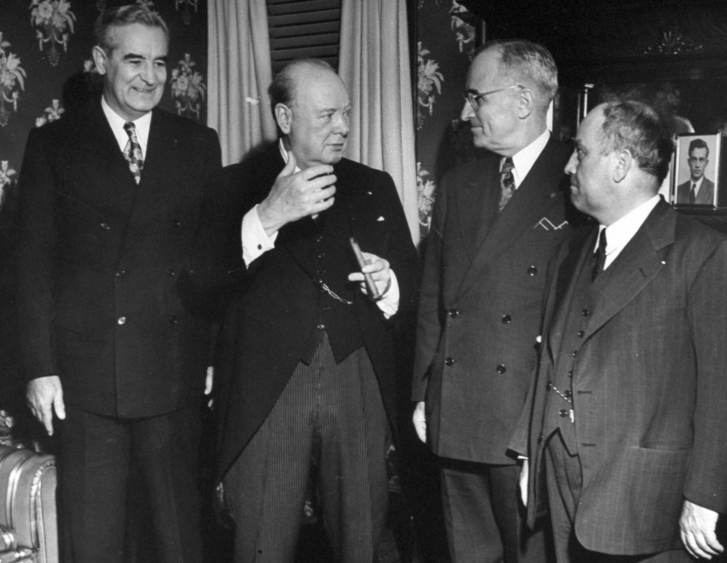 Sir Winston Churchill (2L) talking with President Harry S. Truman (2R).