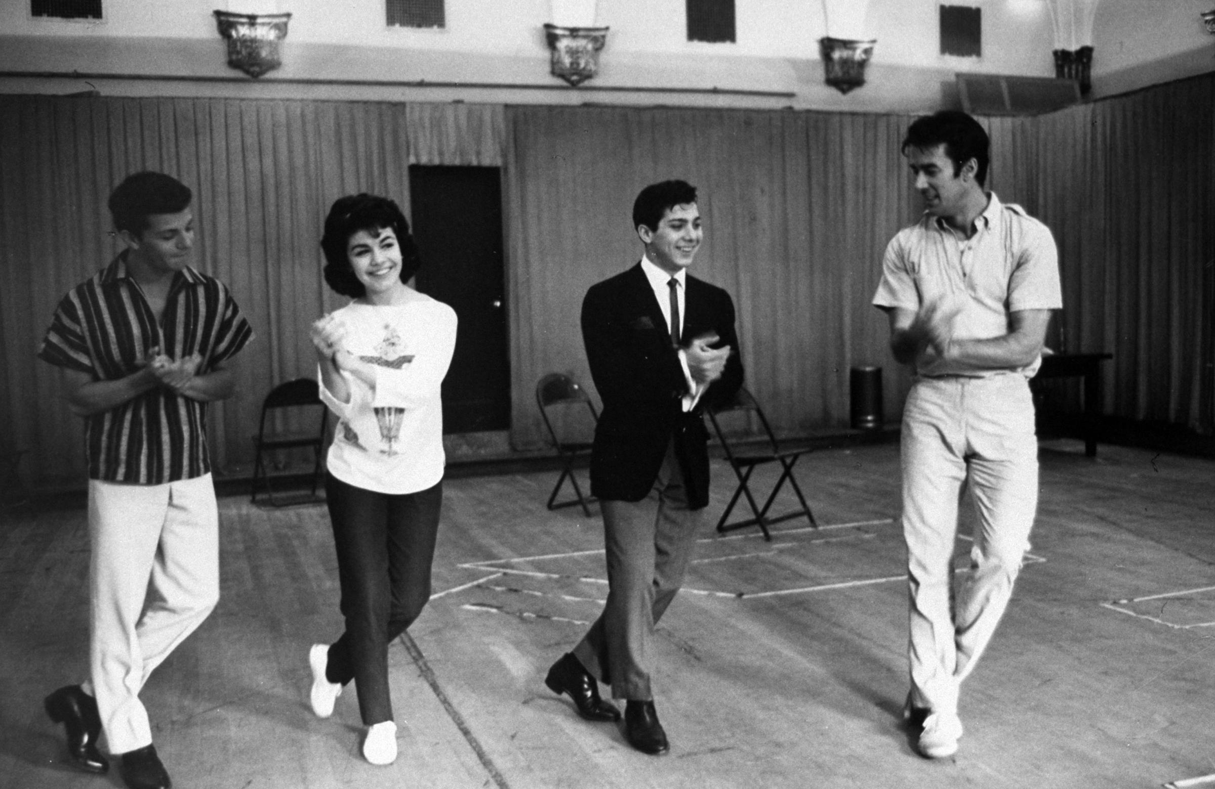 Frankie Avalon, Annette Funicello and Paul Anka rehearsing with a dance instructor, 1960.