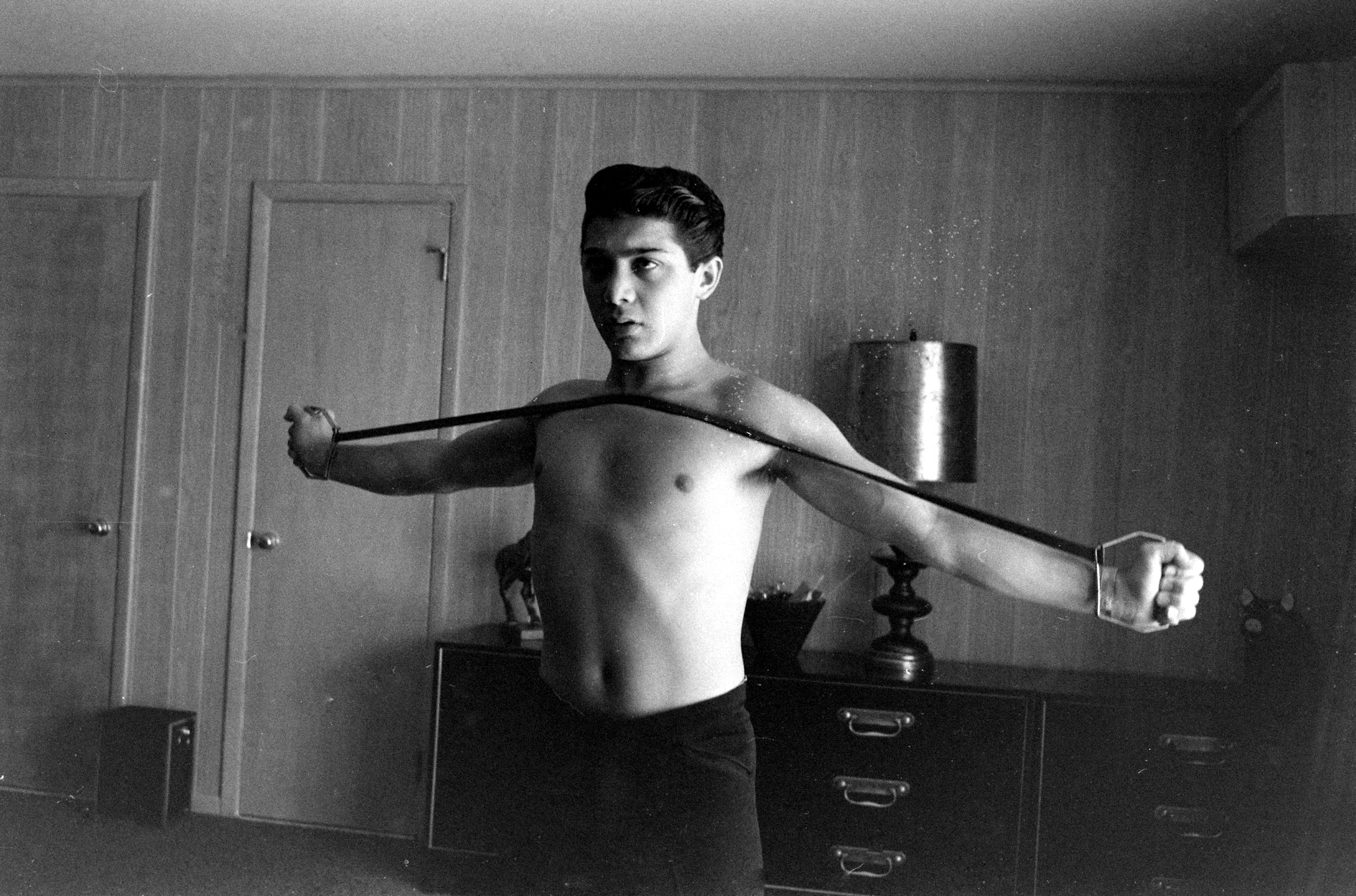 Paul Anka exercising at home, 1960.