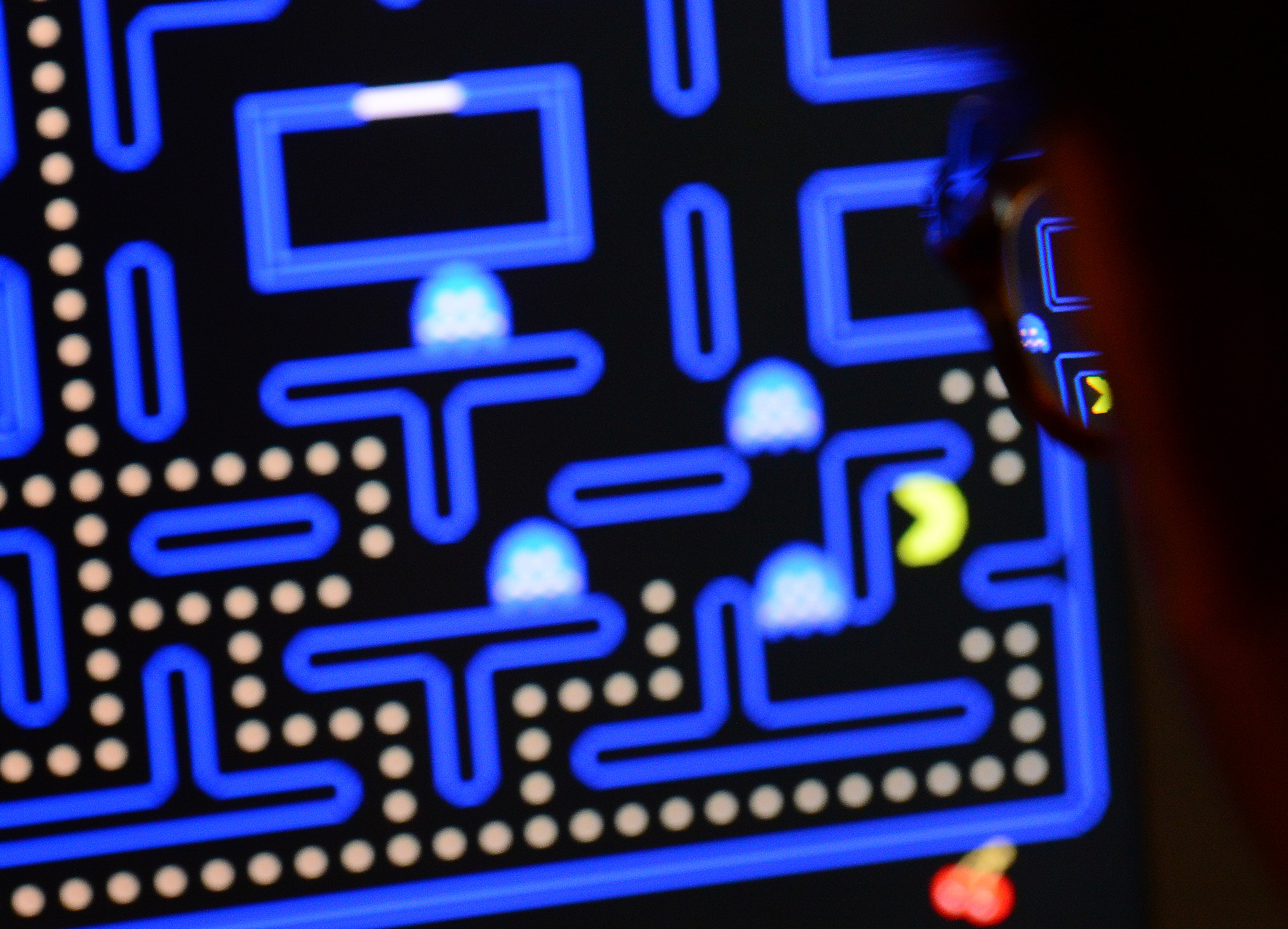 An employee plays the video game Pac-Man (1980) during an exhibition preview featuring 14 video games acquired by The Museum of Modern Art (MoMA)  in New York, March 1, 2013. (Emmanuel Dunand&mdash;AFP/Getty Images)