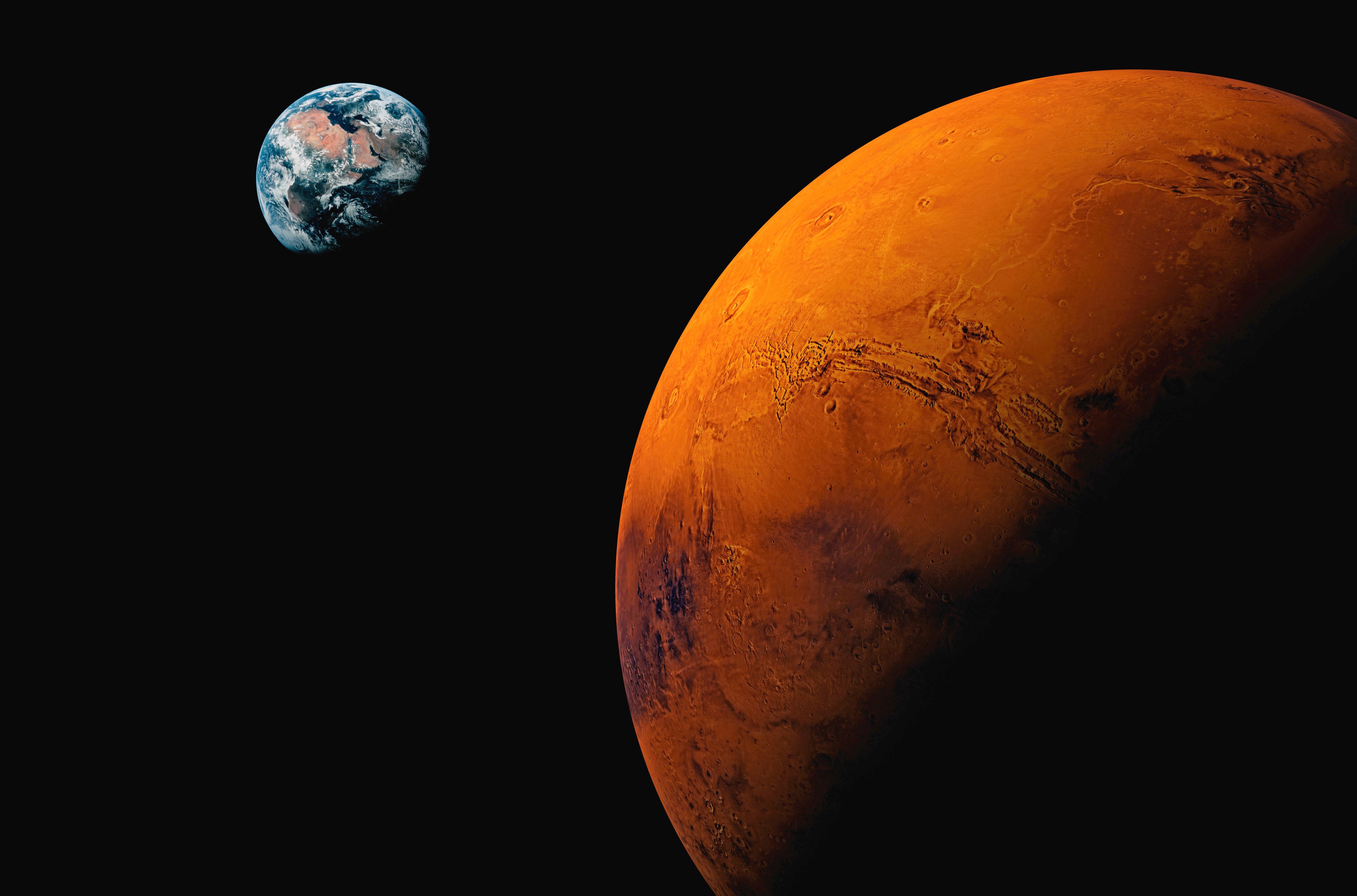 Planet Mars, with Earth visible in the background (Getty Images)