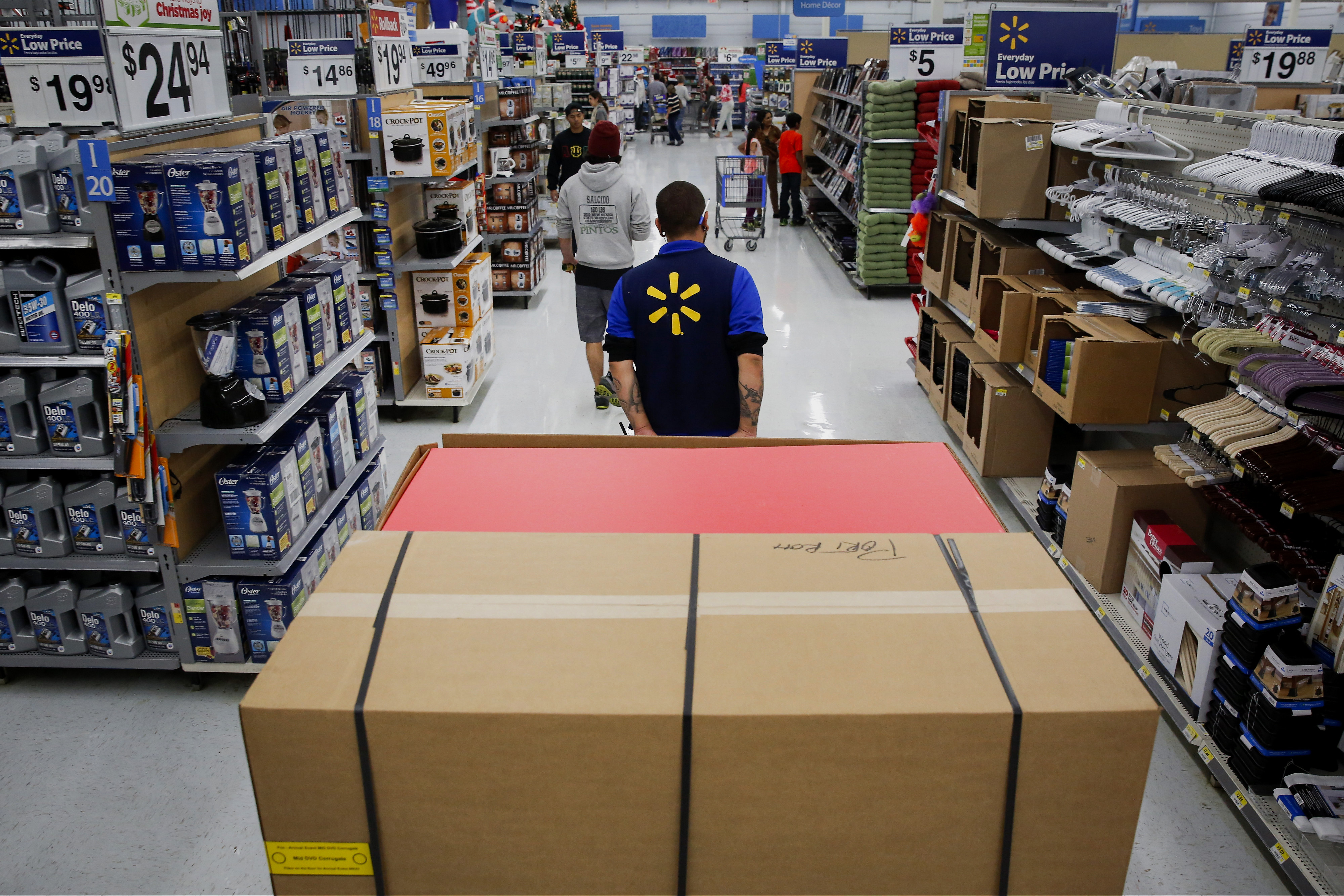 An employee pulls a forklift with display units for DVD movies at a Wal-Mart Stores Inc. location ahead of Black Friday in Los Angeles, Calif. on Nov. 24, 2014. (Bloomberg—Getty Images)