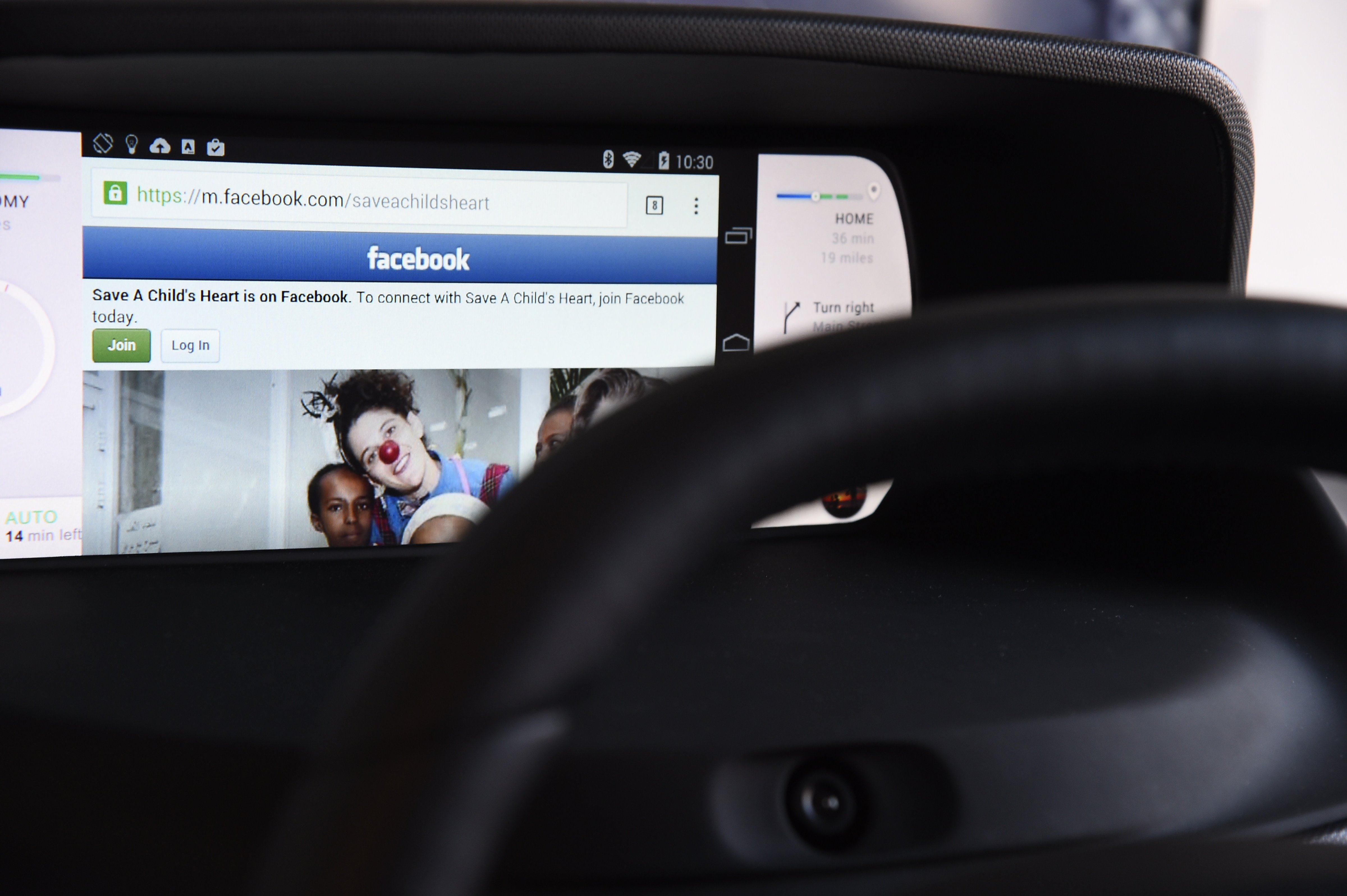 Facebook from a wirelessly connected smartphone is seen on an autonomous dashboard. (Robyn Beck—Getty Images)