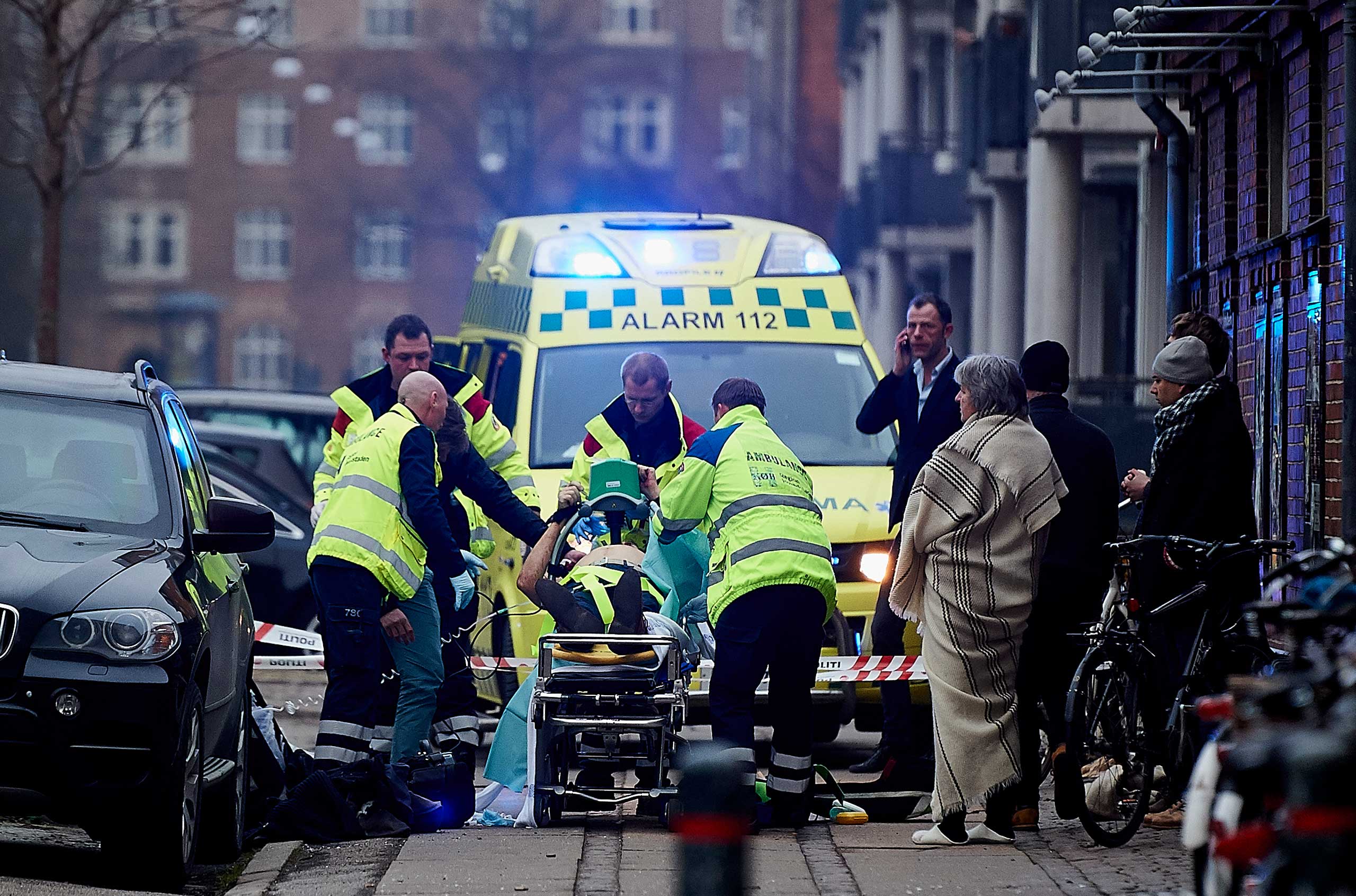 A victim is carried into an ambulance after a shooting at a public meeting and discussion arranged by the Lars Vilks Committee about Charlie Hebdo and freedom of speech on Feb. 14, 2015 in Copenhagen. (Lars Ronbog—Getty Images)