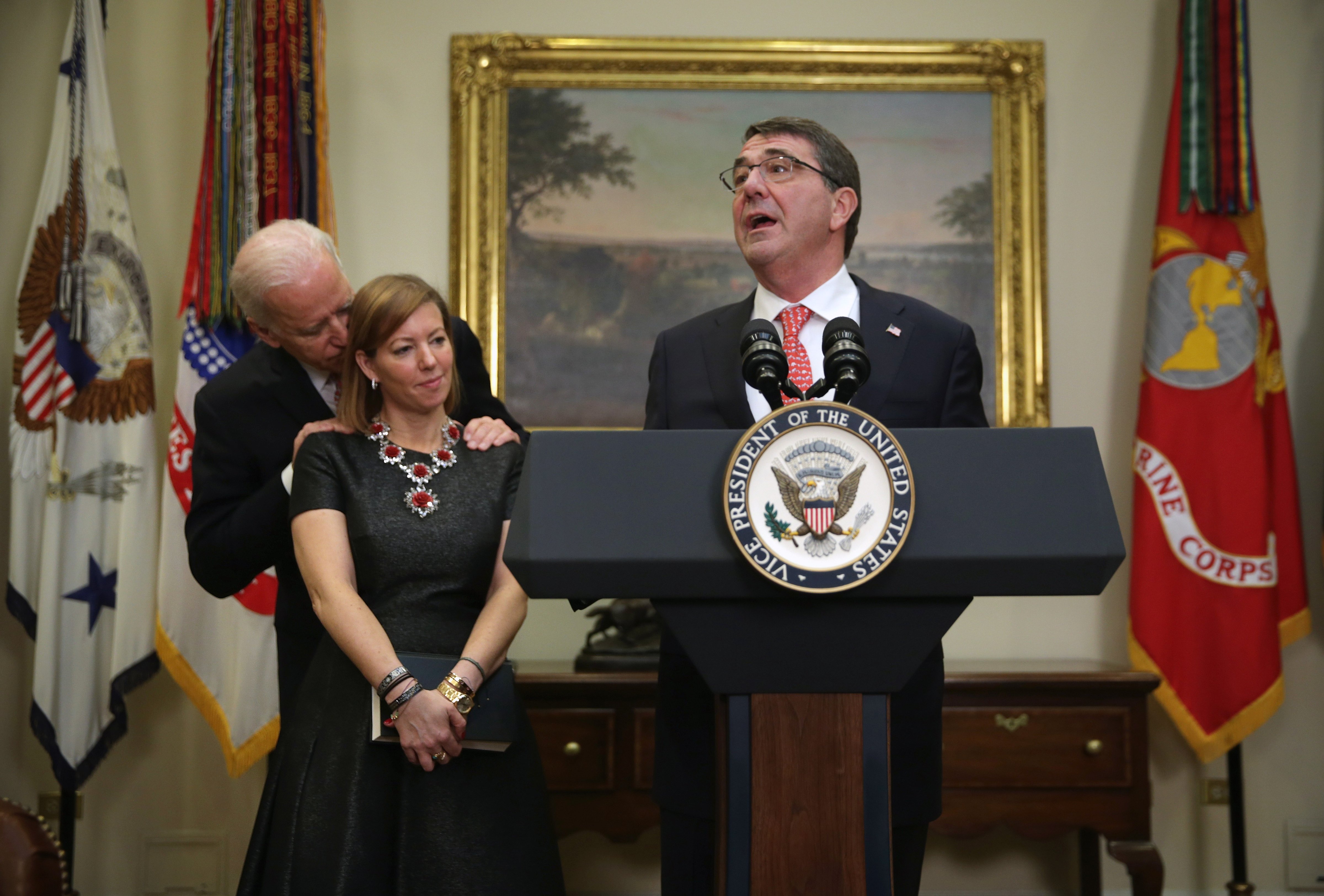 Secretary of Defense Ashton Carter delivers remarks after being sworn in during a ceremony in the White House in Washington. D.C. while his wife Stephanie Carter and Vice President Joseph Biden observe on Feb. 17, 2015. (Alex Wong—Getty Images)