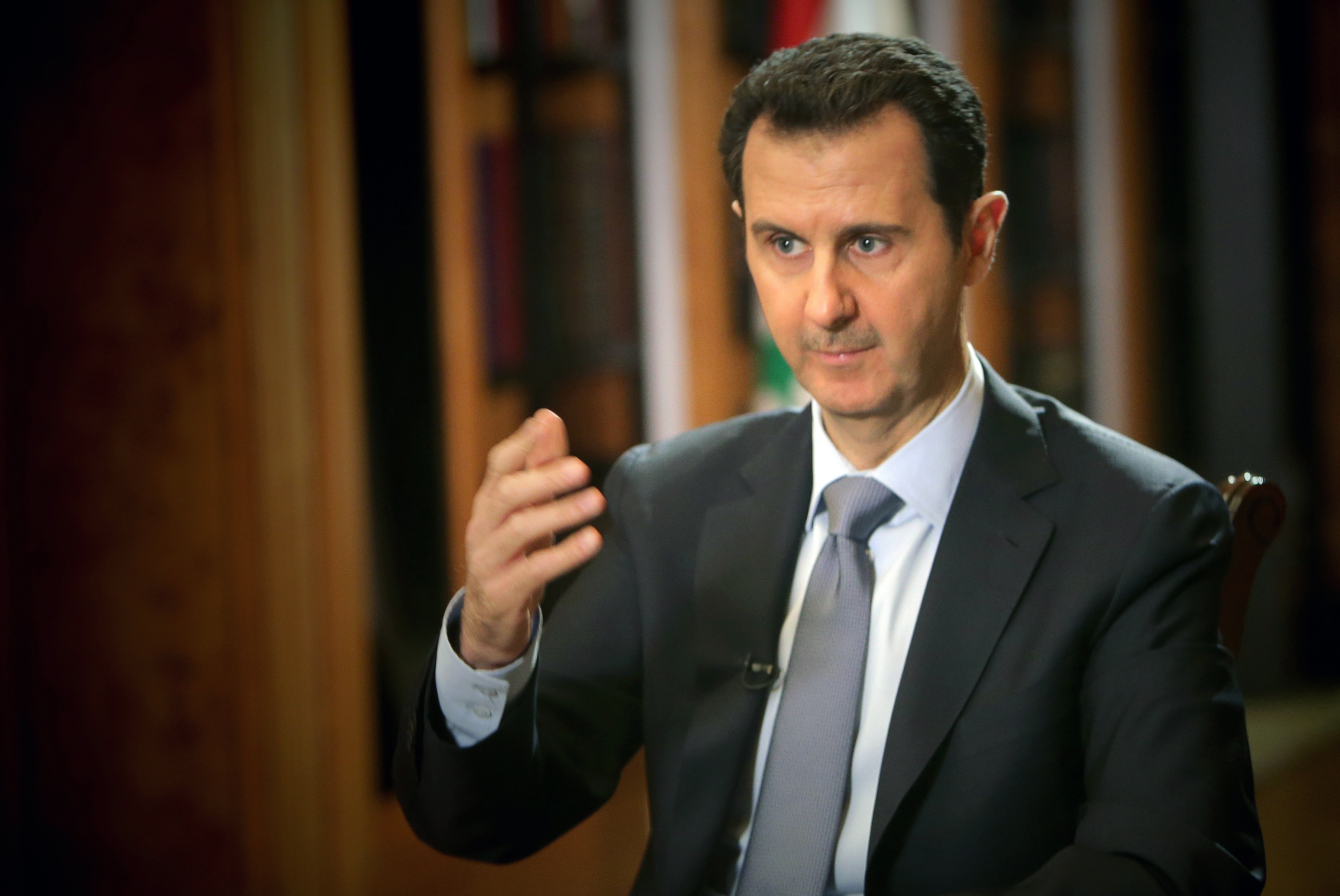 Syrian President Bashar al-Assad speaks during an interview with AFP at the presidential palace in Damascus on January 20, 2014. (Joseph Eid—AFP/Getty Images)