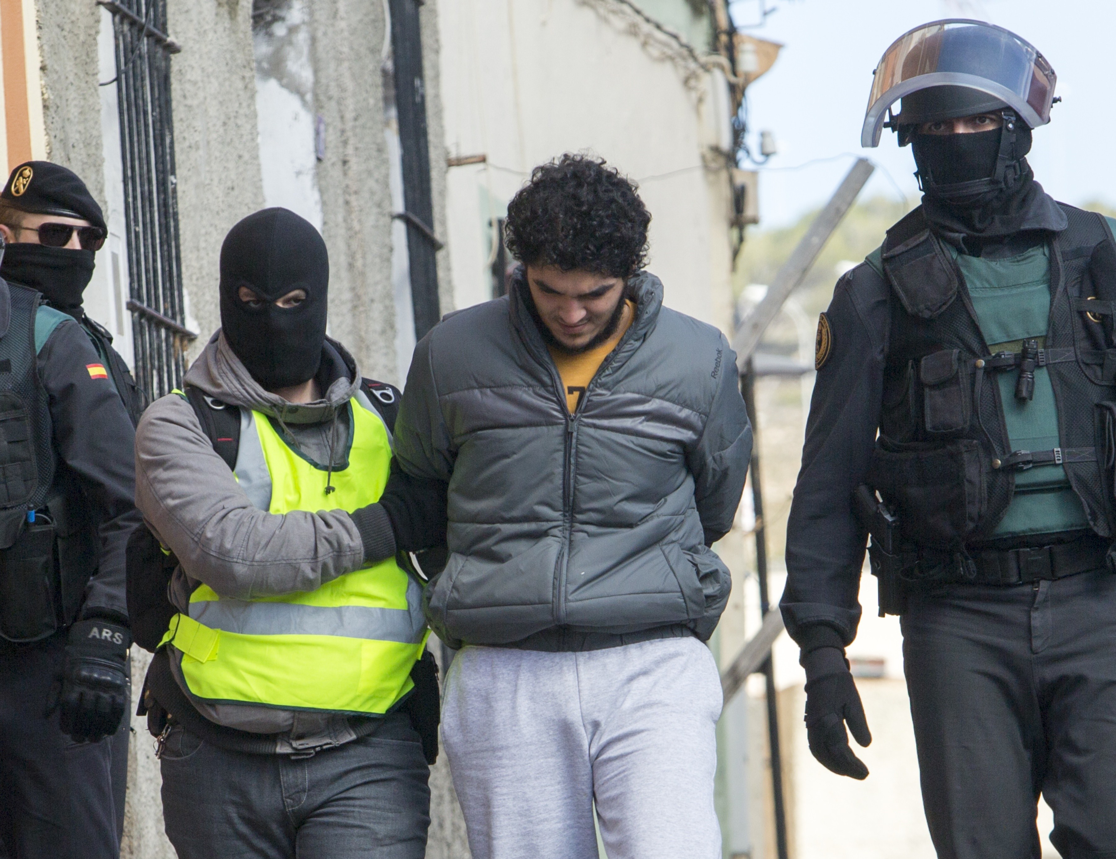 One of four people suspected of creating and operating several Internet platforms spreading propaganda, particularly for the Islamic State group in a bid to recruit young women to join Islamic State militants is arrested in Melilla, Spain, on February 24, 2015. (Angela Rios—AFP/Getty Images)