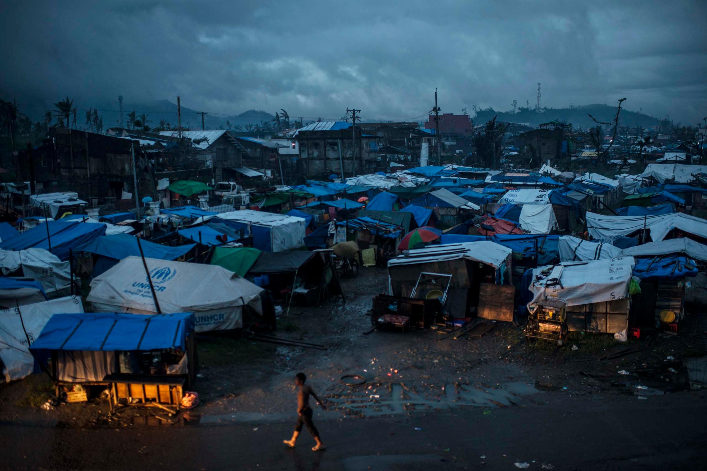 Jan. 13, 2014: Residents displaced by Typhoon Haiyan live in tents outside the stadium in Tacloban, in the Philippines.