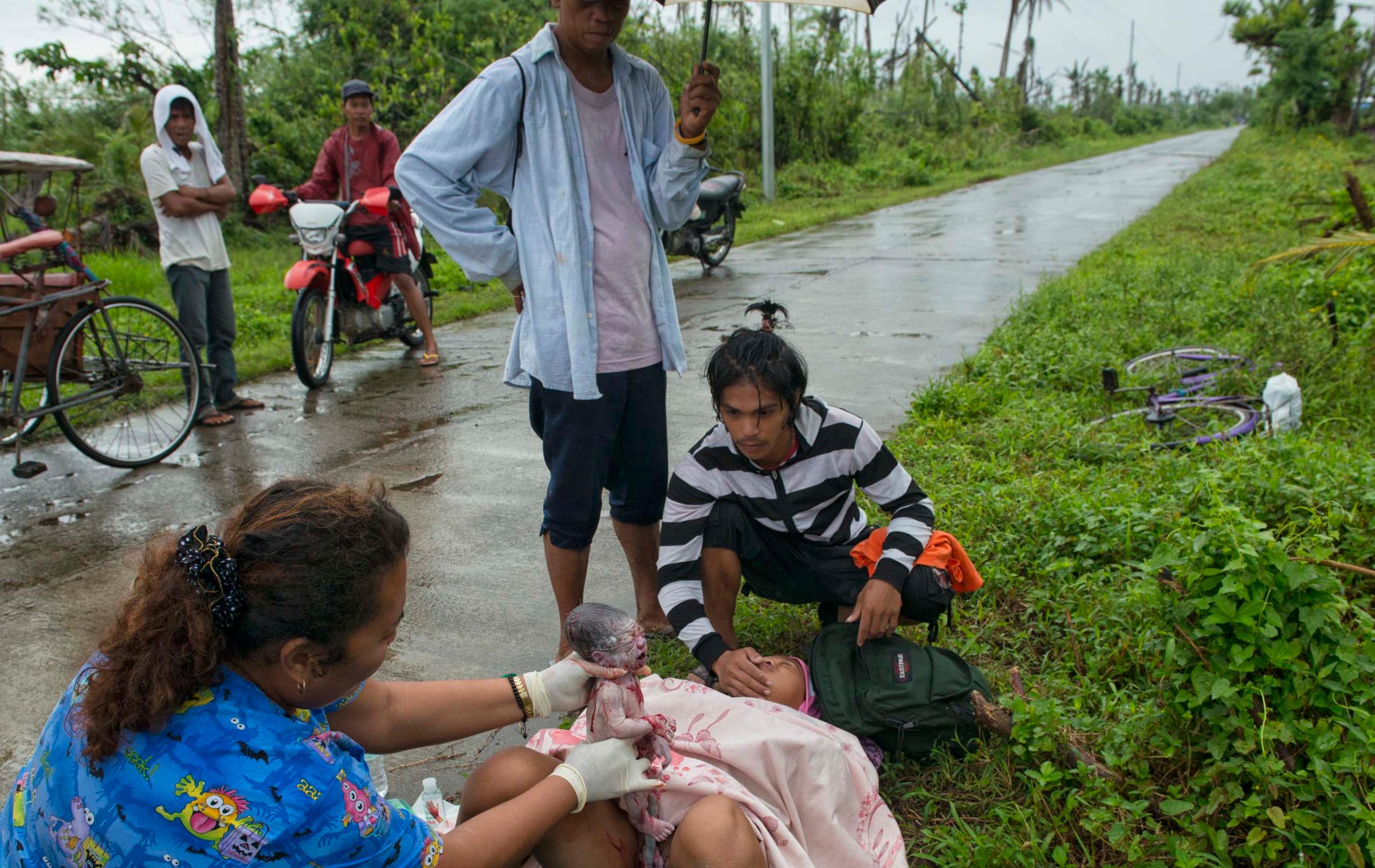 Jan. 11, 2014: Analyn Pesado, 18, gives birth on the side of the road en route to the nearest clinic in Tolosa, outside of Tacloban.