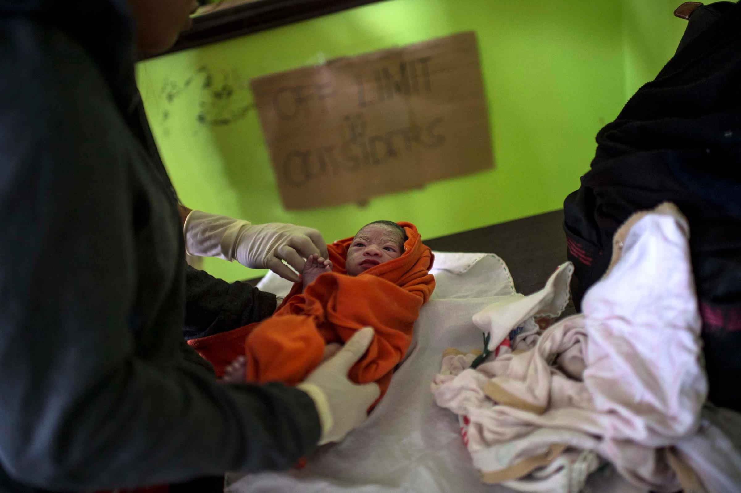 Jan. 11, 2014: Analyn Pesado's baby is monitored at the clinic in Tolosa.