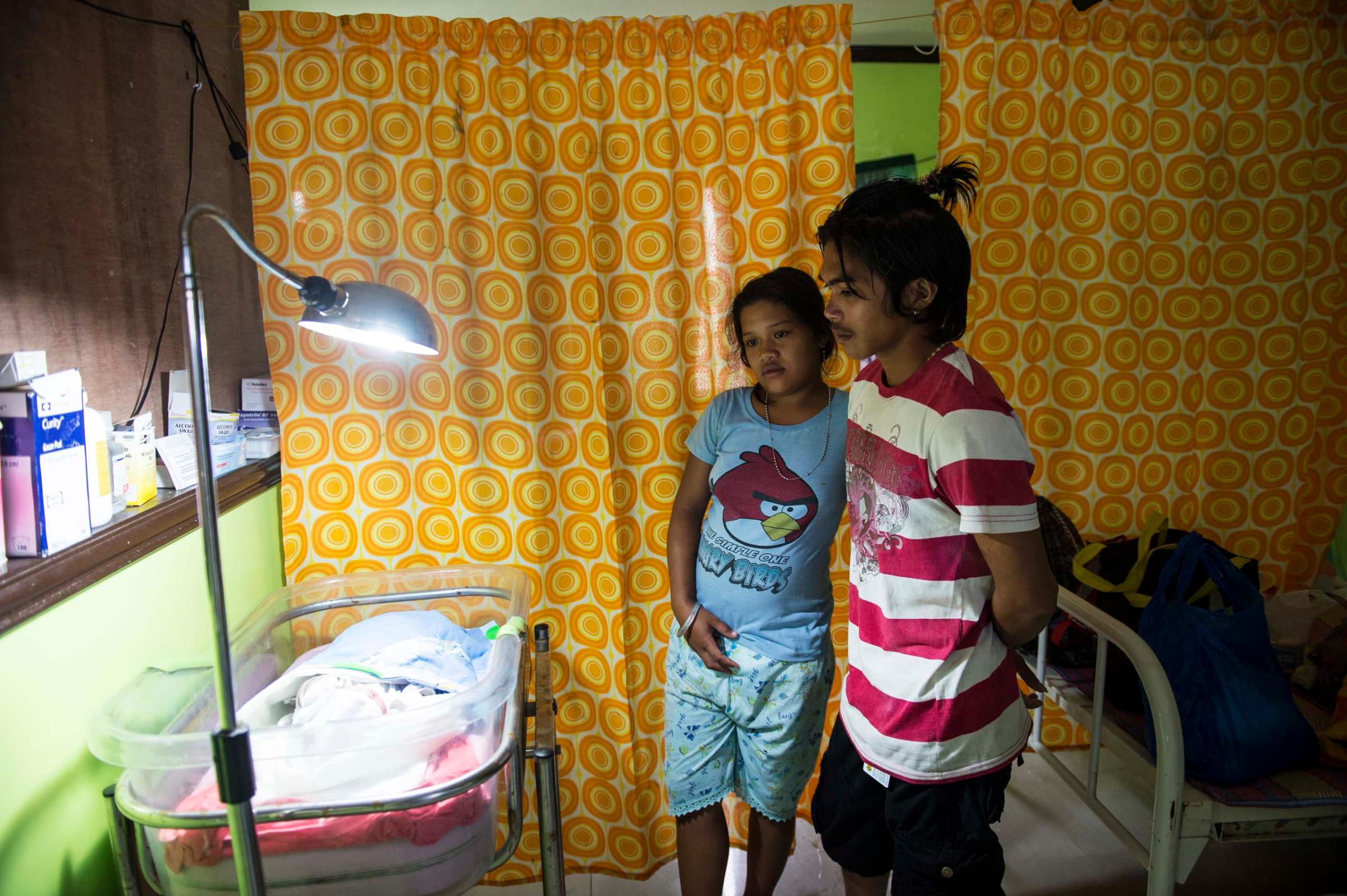 Jan.11, 2014: Analyn Pesado and Ryan Bacate watch over their new born son at the clinic in Tolosa, in the Philippines.