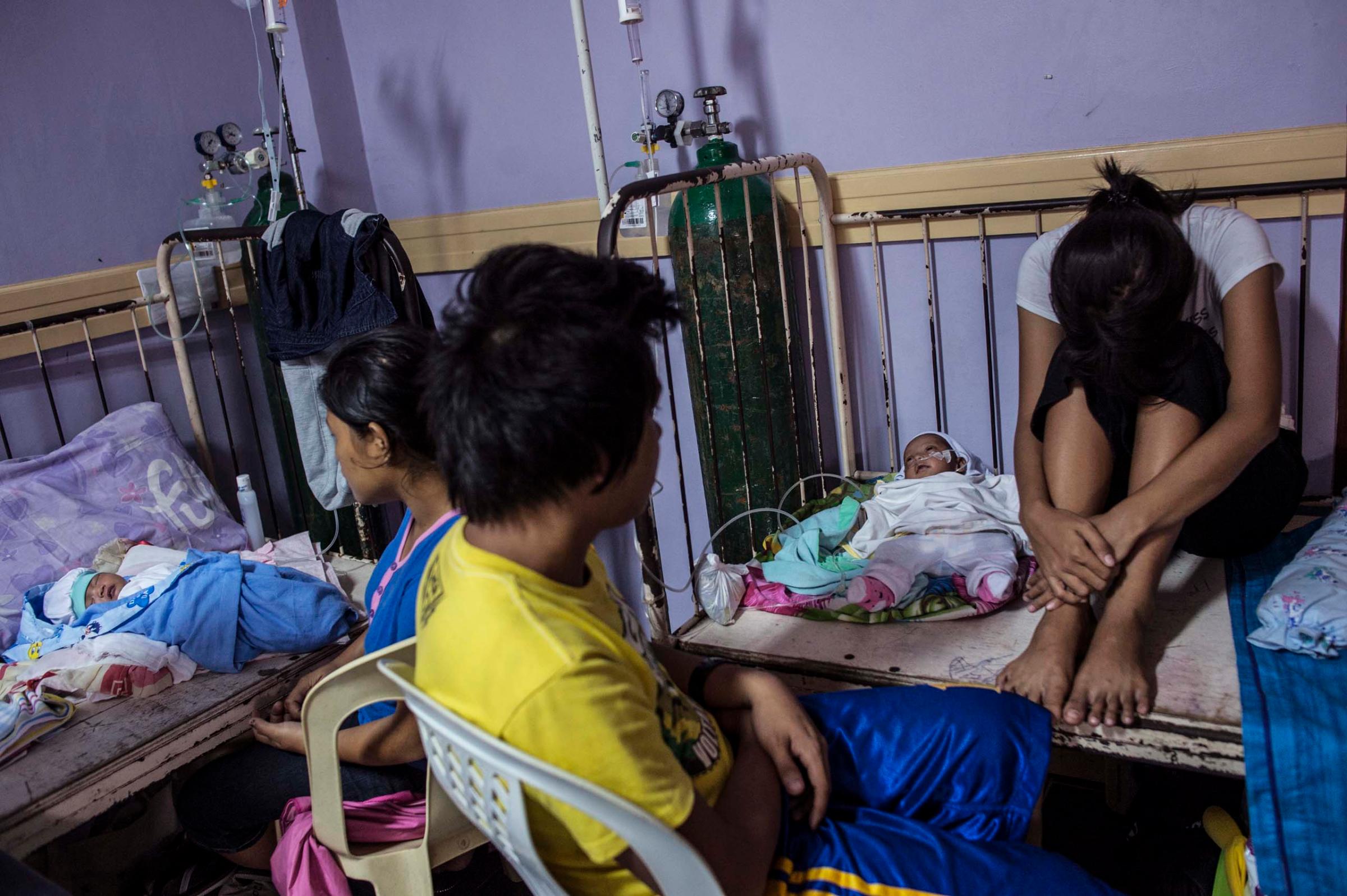 Jan. 12, 2014: Families at the neonatal intensive care unit (NICU) at a government hospital in Tacloban. Overcrowding is due to mothers with a higher number of complications in pregnancy and lack of prenatal care.