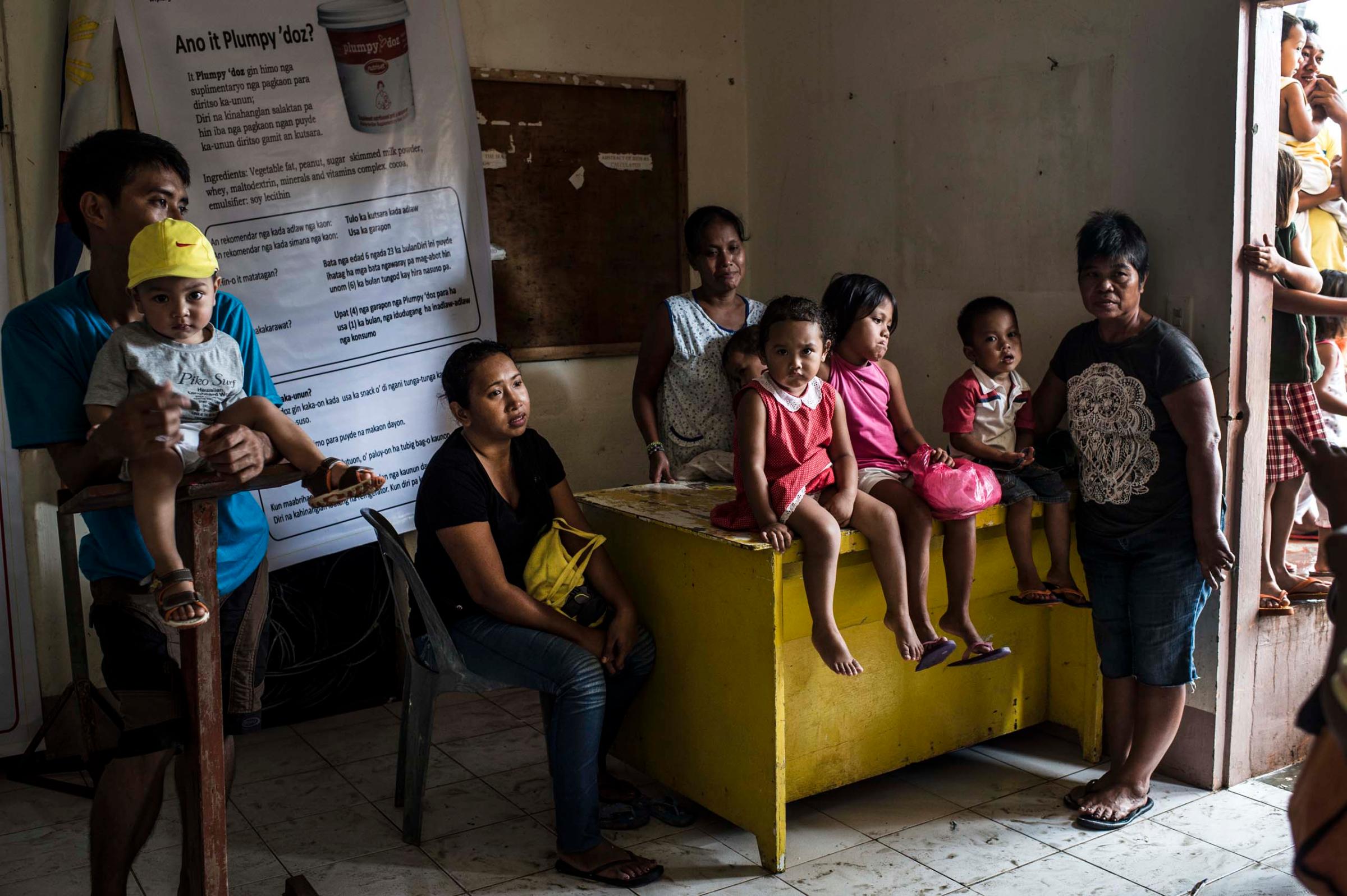 Jan. 15, 2014: Children and parents wait for Save the Children staff who are conducting nutritional assessments and distributing plumpy nut and biscuits for children under five in Palo, outside of Tacloban, in the Philippines.