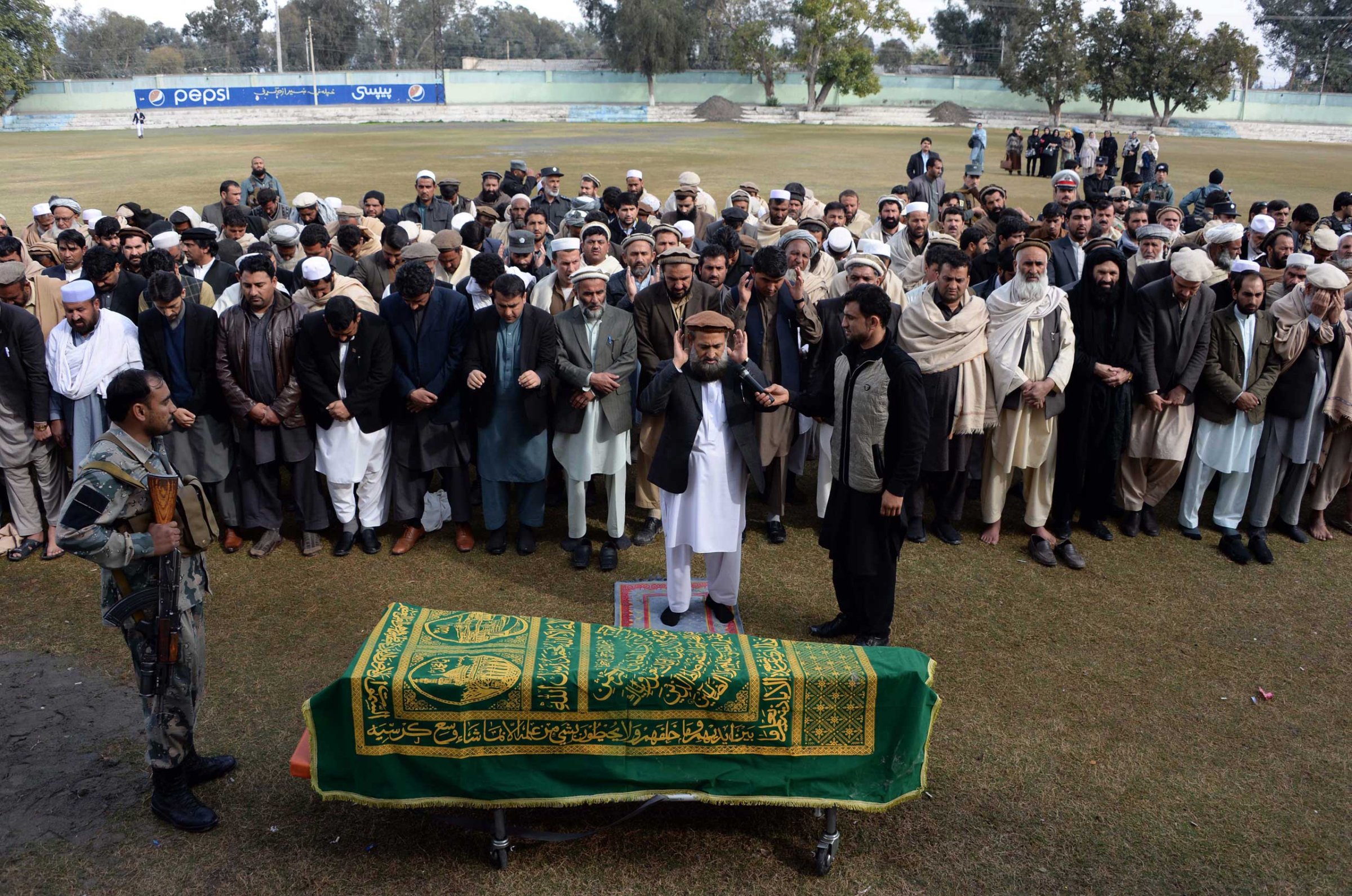 Afghan officials and mourners perform funeral prayers over the coffin of Angiza Shinwari, a provincial member, in Jalalabad on Feb. 16, 2015.