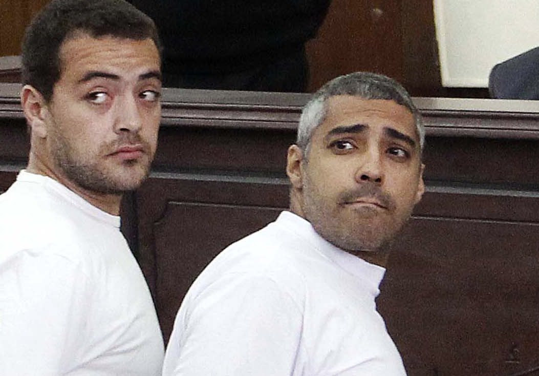 In this March 31, 2014 file photo, Al-Jazeera English producer Baher Mohamed, left, Canadian-Egyptian acting Cairo bureau chief Mohammed Fahmy, right, appear in court along with several other defendants during their trial on terror charges, in Cairo. (Heba Elkholy&mdash;AP)