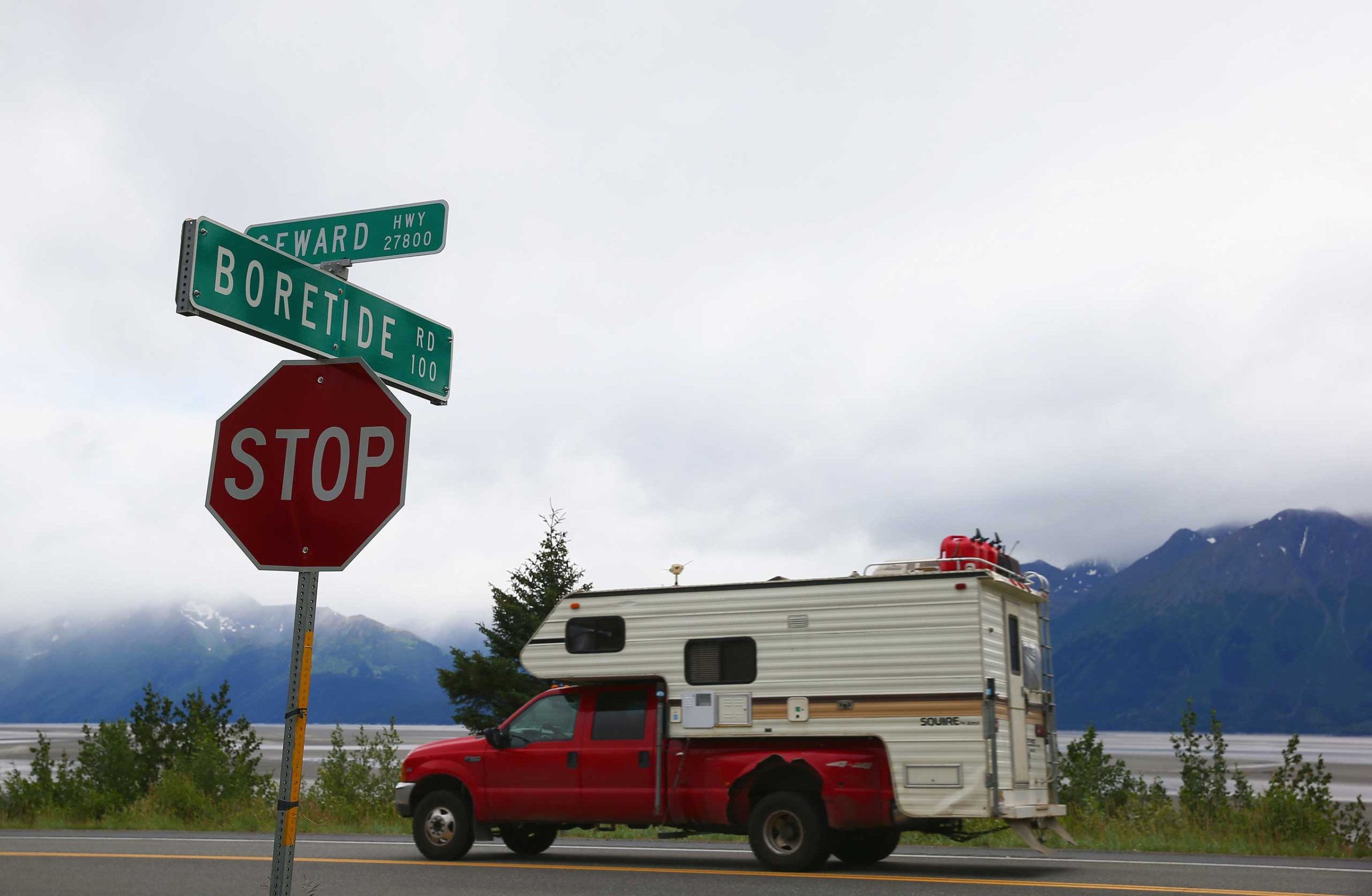 A truck passes a street sign named for the Bore Tide at Turnagain Arm in Anchorage, Alaska, in 2014.