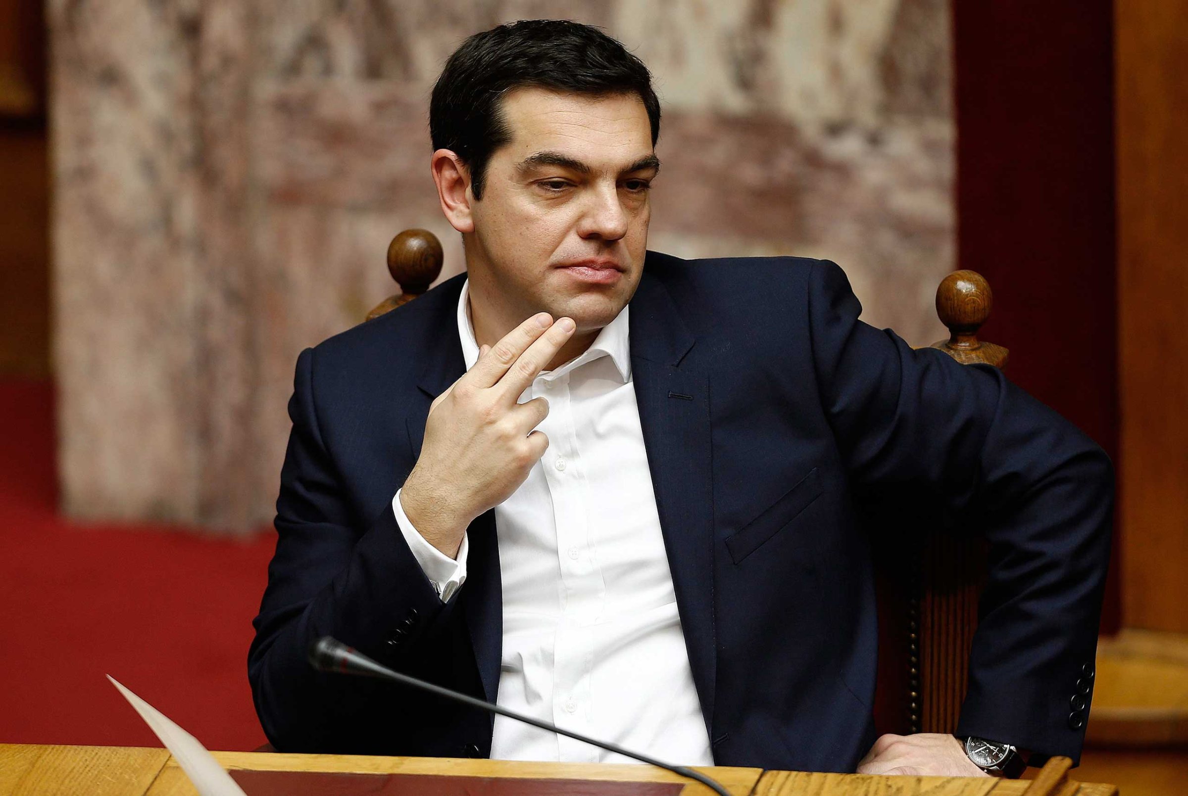 Greek Prime Minister Alexis Tsipras looks on before swearing in ceremony of the new deputies that were elected in the January 25 national polls, in Athens, Feb. 5,2015.