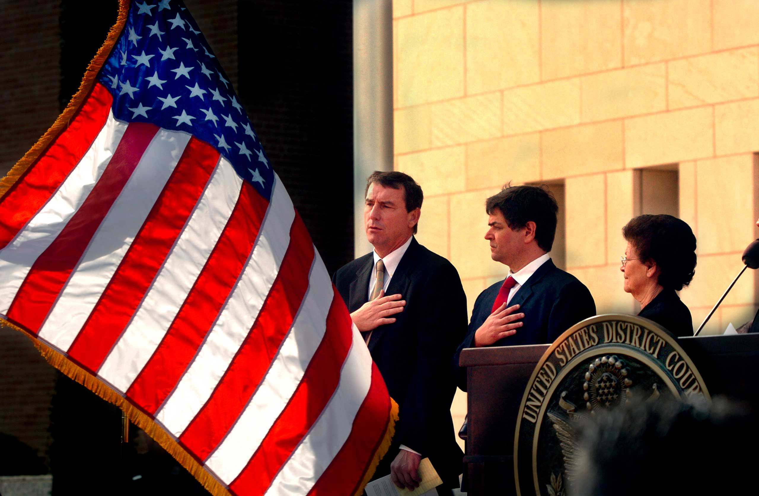 U.S. Southern District Judge Andrew S. Hanen, left, recites the Pledge of Allegiance during the United States Courthouse naming ceremony in Brownsville, Texas, Nov. 14, 2005. (Brad Doherty—Brownsville Herald/AP)