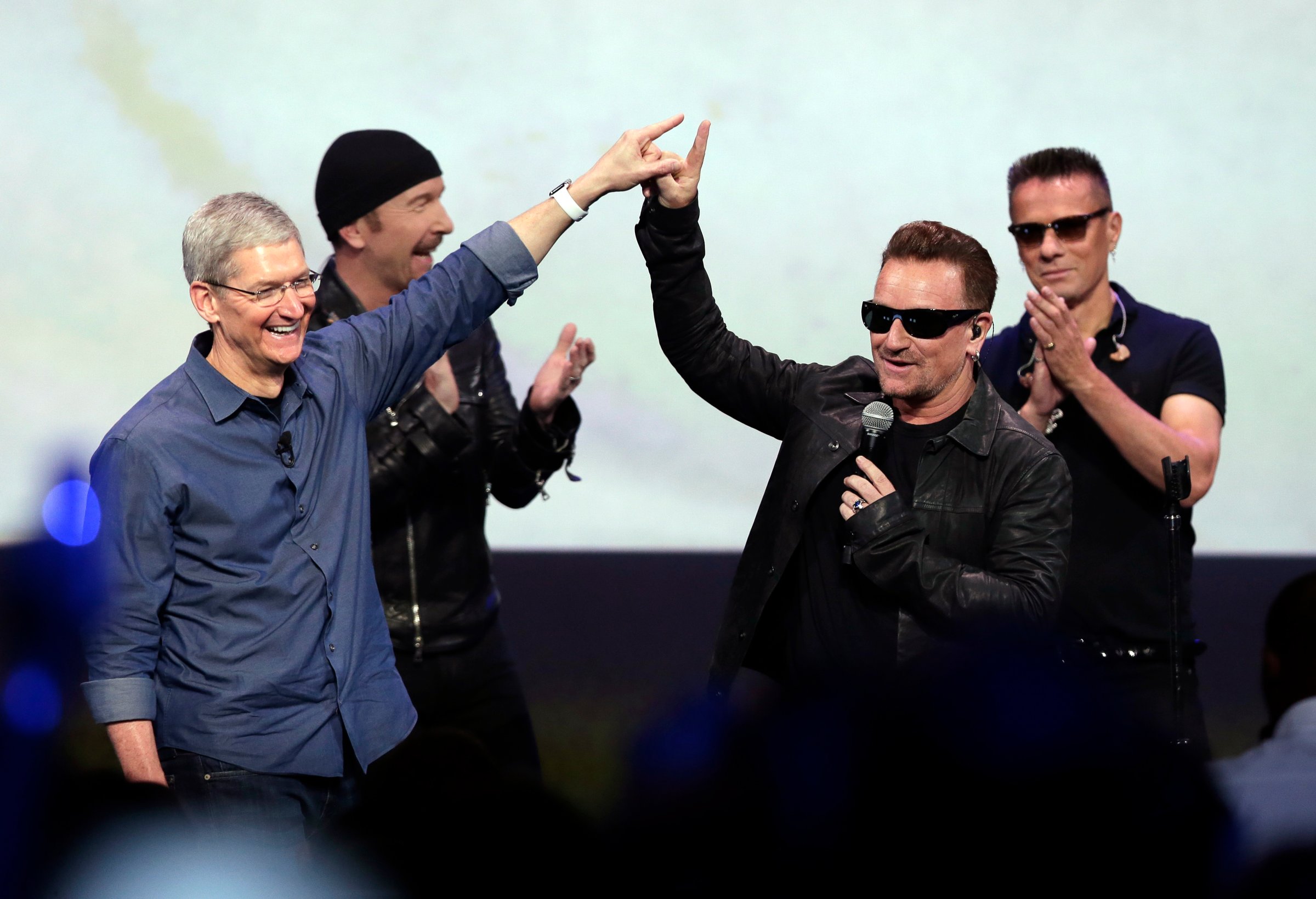 In this Sept. 9, 2014 file photo, Apple CEO Tim Cook (L) greets Bono from the band U2 after they preformed at the end of the Apple event in Cupertino, Calif.