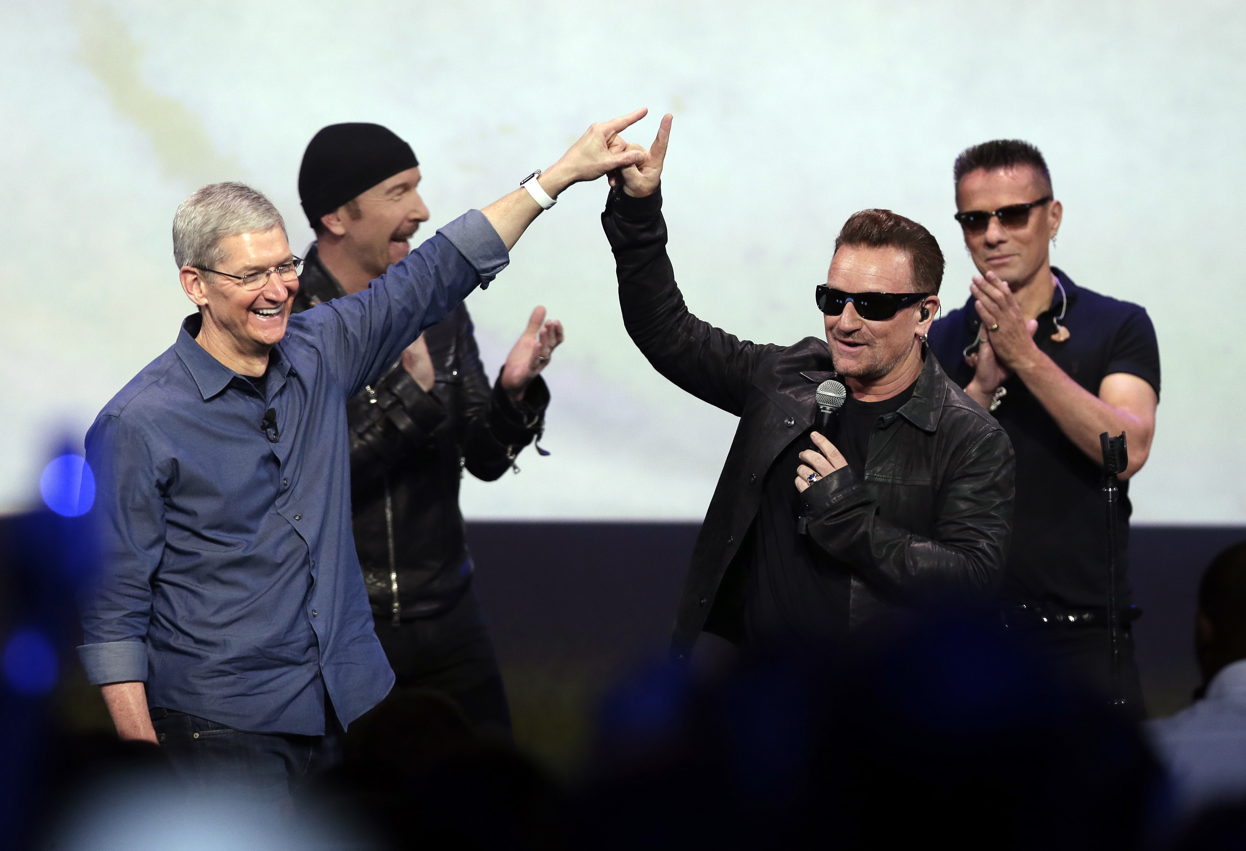 In this Sept. 9, 2014 file photo, Apple CEO Tim Cook (L) greets Bono from the band U2 after they preformed at the end of the Apple event in Cupertino, Calif. (Marcio Jose Sanchez—AP)