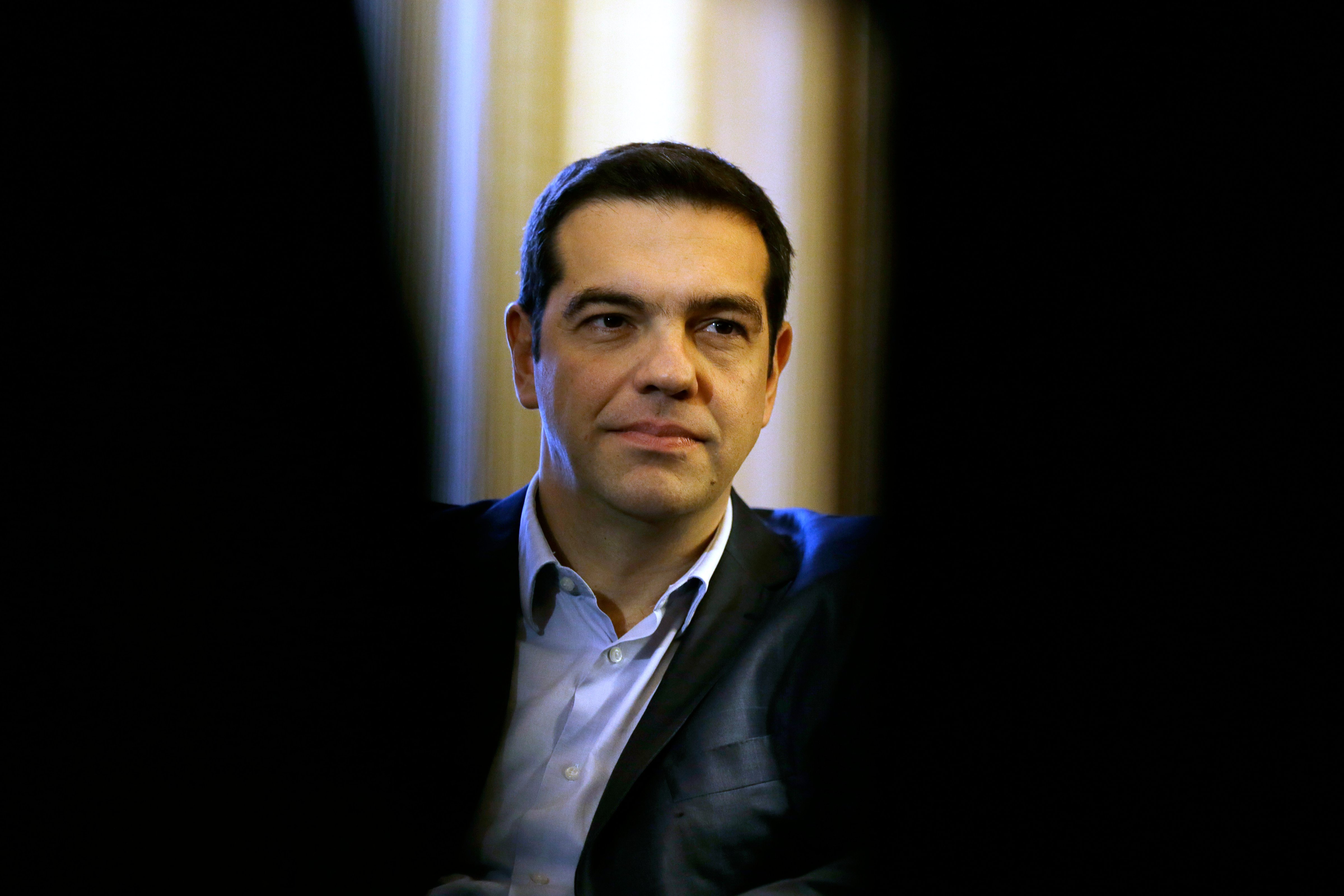 Greece Prime Minister Alexis Tsipras listens to Greek President Karolos Papoulias during their meeting at Presidential Palace in Athens, Greece on Feb. 18, 2015.