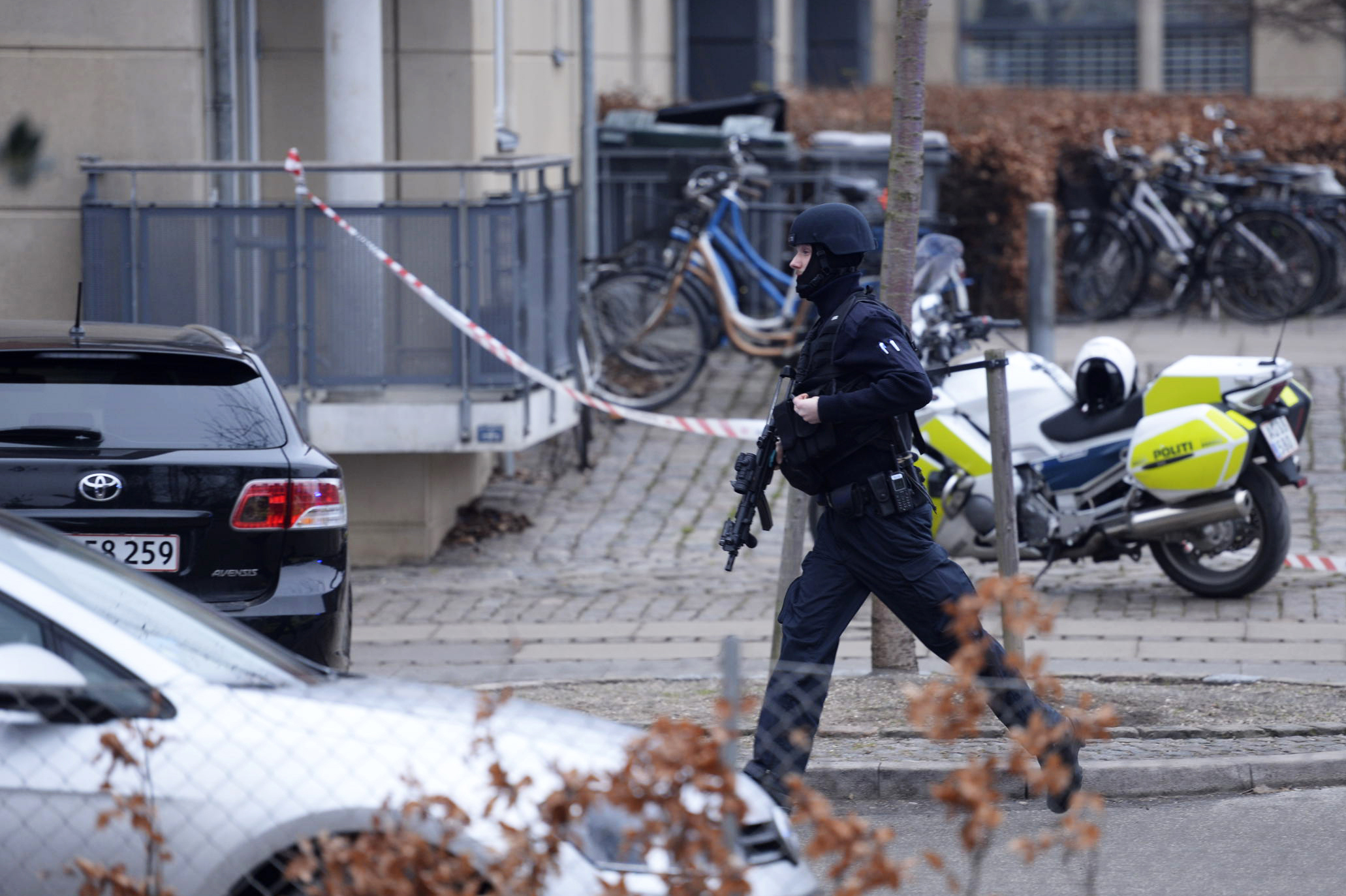 An armed security officer runs down a street near a venue after shots were fired where an event titled  "Art, blasphemy and the freedom of expression" was being held in Copenhagen, Saturday, Feb. 14, 2015. (Kenneth Meyer—AP)