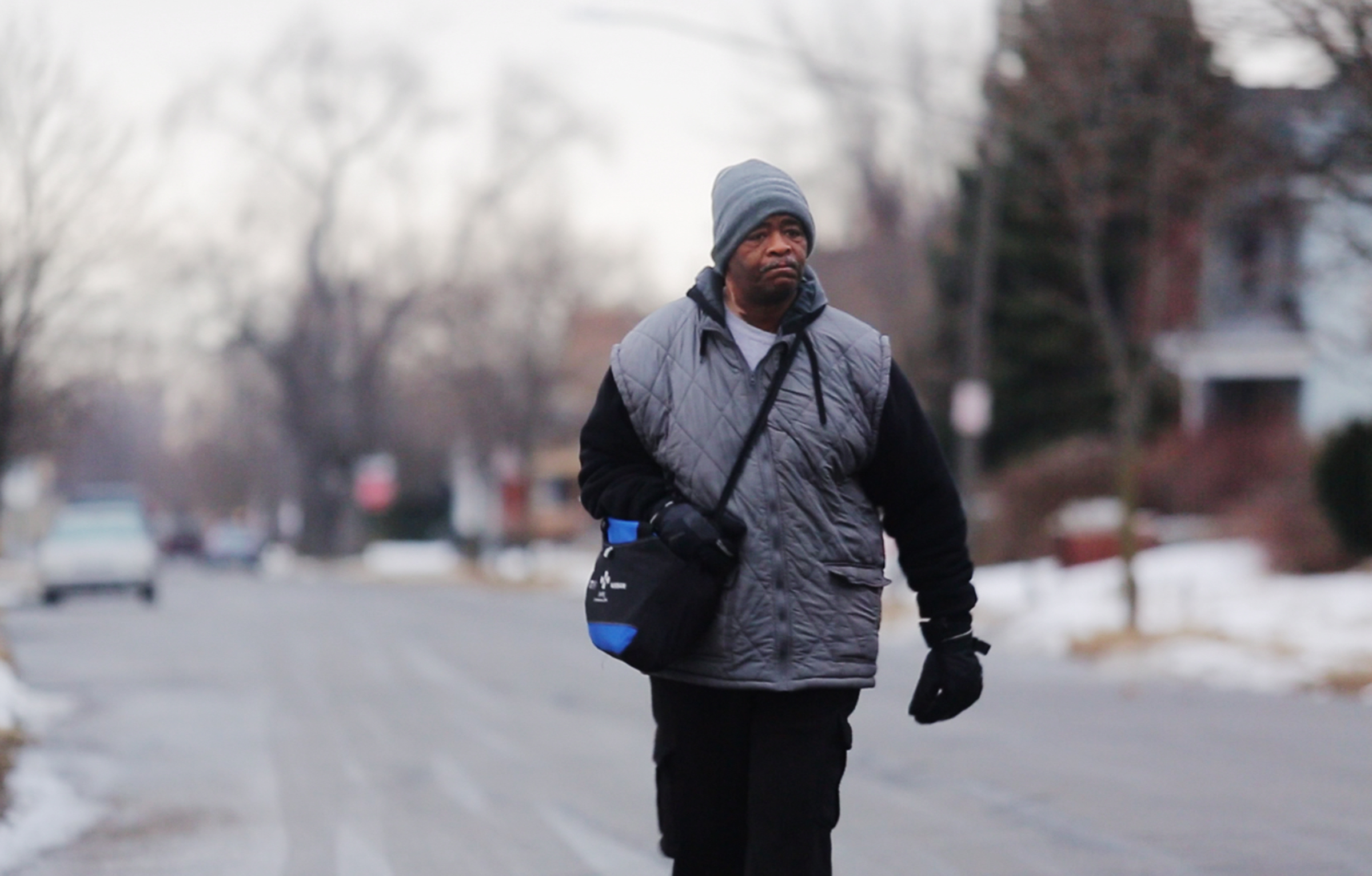 In this Jan. 29, 2015, photo, James Robertson, 56, of Detroit, walks toward Woodward Aveune in Detroit to catch his morning bus to Somerset Collection in Troy before walking to his job at Schain Mold Engineering in Rochester Hills. Getting to and from his factory job 23 miles away in Rochester Hills, he'll take a bus partway there and partway home and walk 21 miles according to the Detroit Free Press (Ryan Garza—AP)