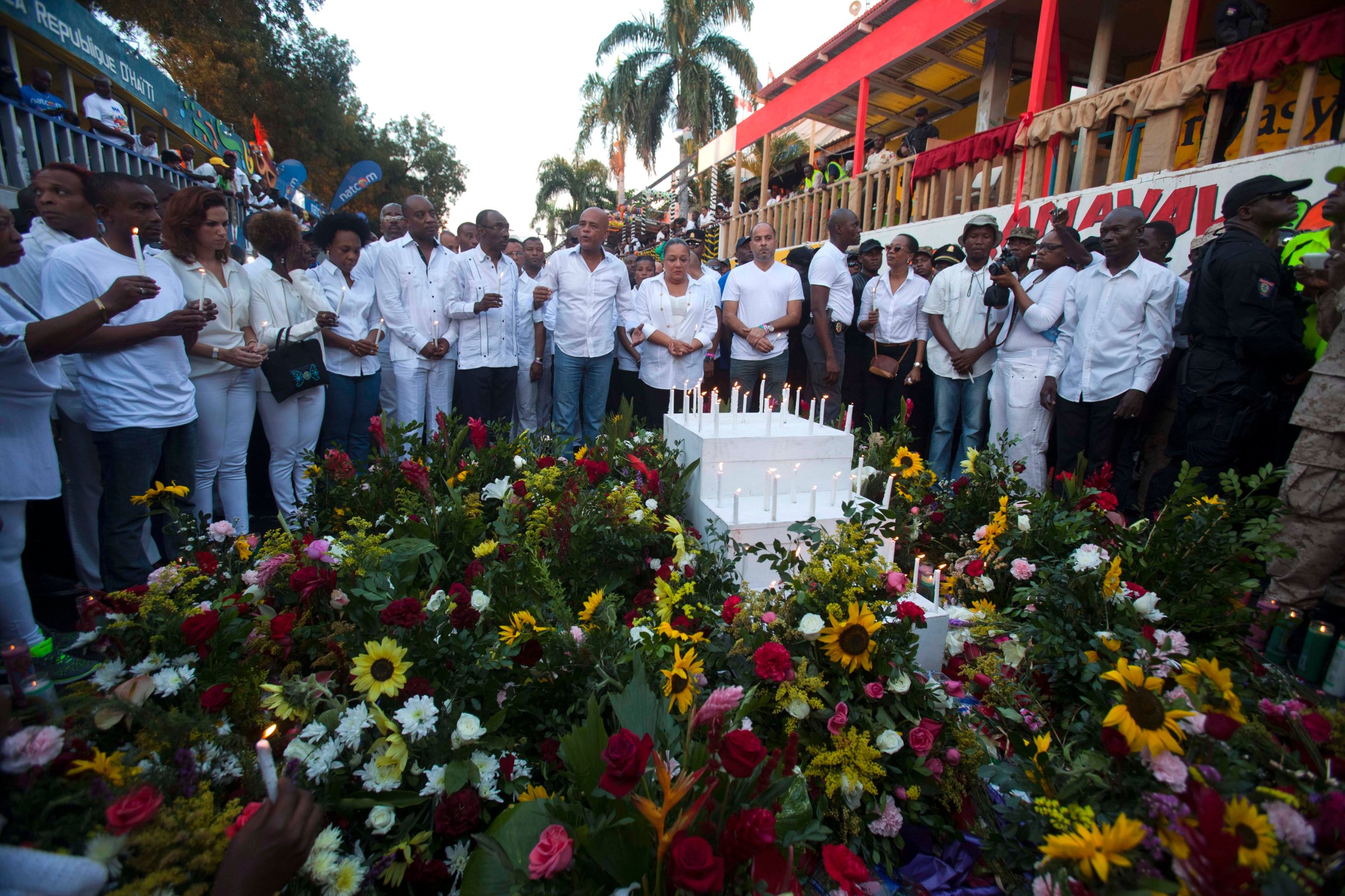 Haiti's President Michel Martelly, center left, and first lady Sophia Martelly, right center, stand at a memorial in Port-au-Prince, Haiti, Feb. 17, 2015