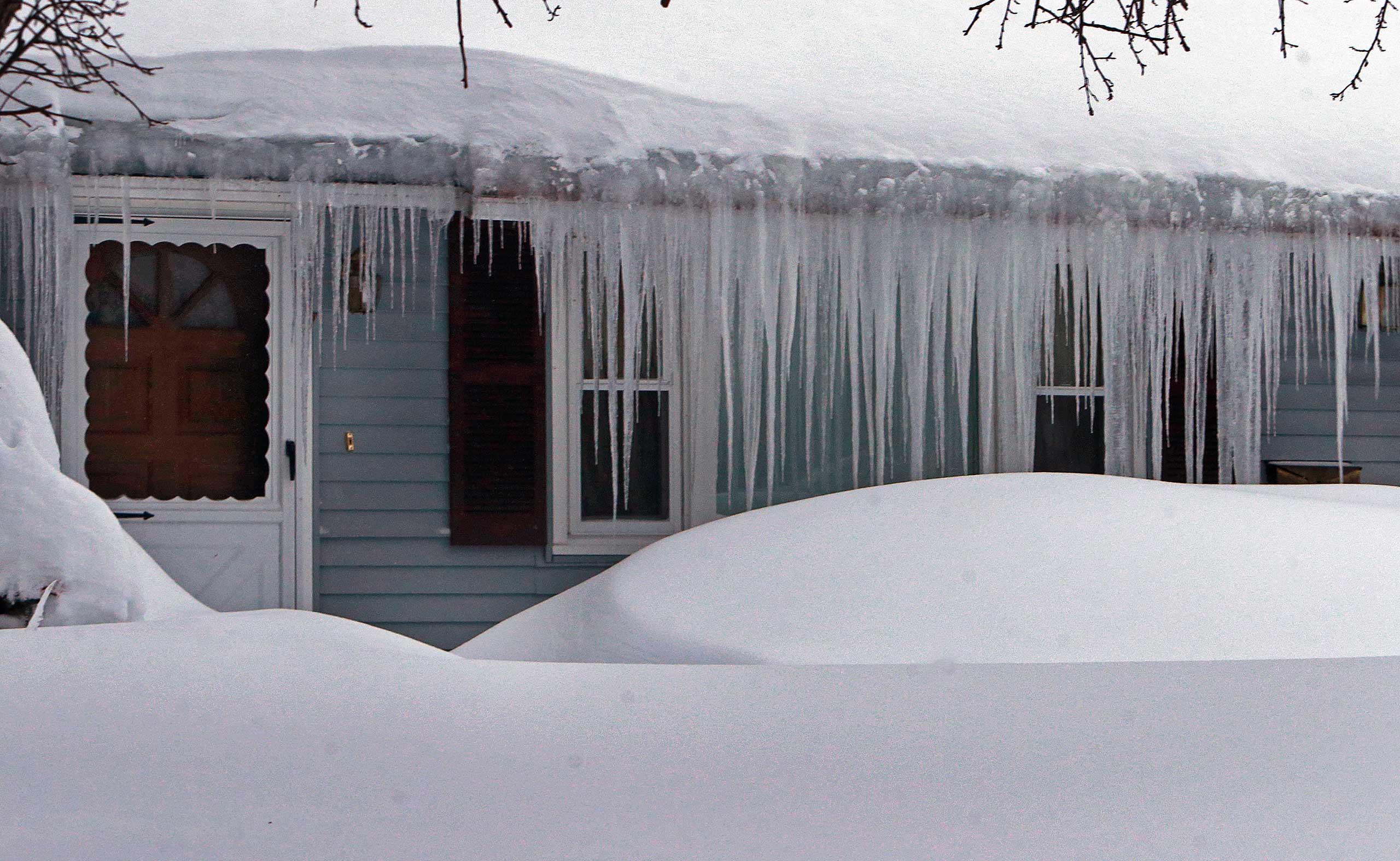 A house is covered in snow and ice on Jane Road in Methuen, Mass. on Feb. 9, 2015.