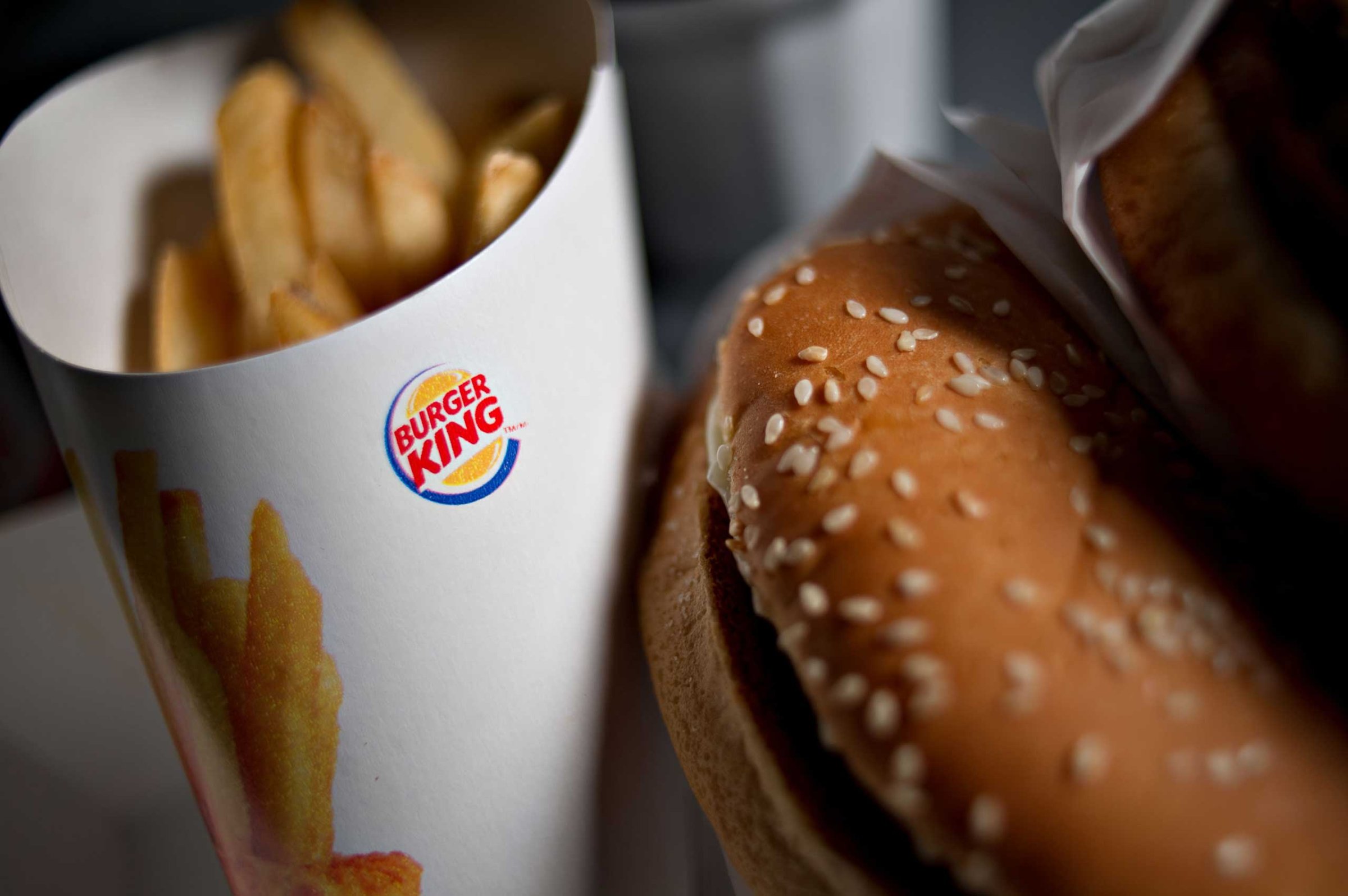 A Burger King Whopper hamburger is arranged with french fries for a photograph in Tiskilwa, Illinois, U.S., on Wednesday, Feb. 13, 2013.