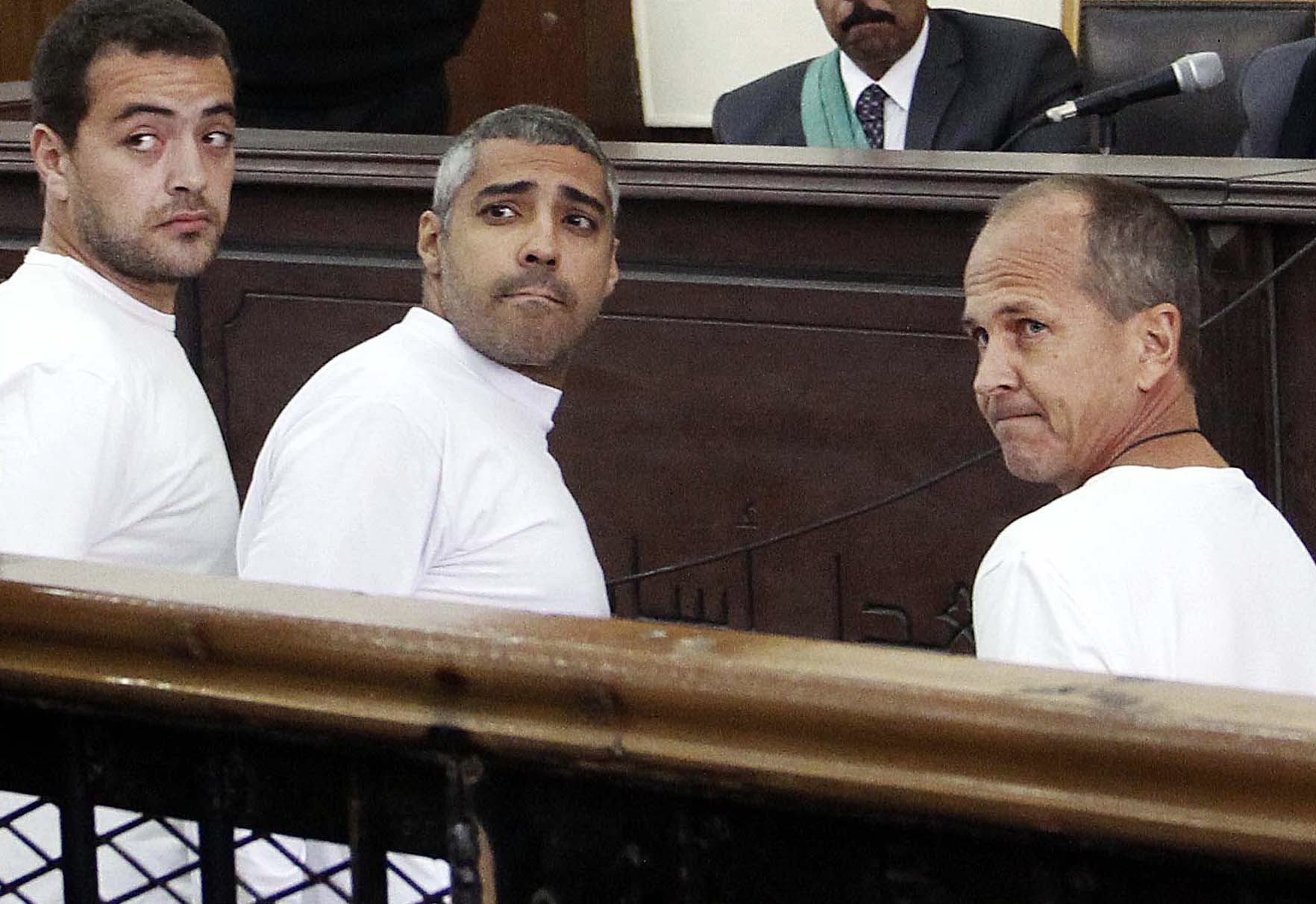 From left: al-Jazeera English producer Baher Mohamed, Canadian-Egyptian acting Cairo bureau chief Mohammed Fahmy and correspondent Peter Greste appear in court in Cairo on March 31, 2014 (Heba Elkholy—AP)