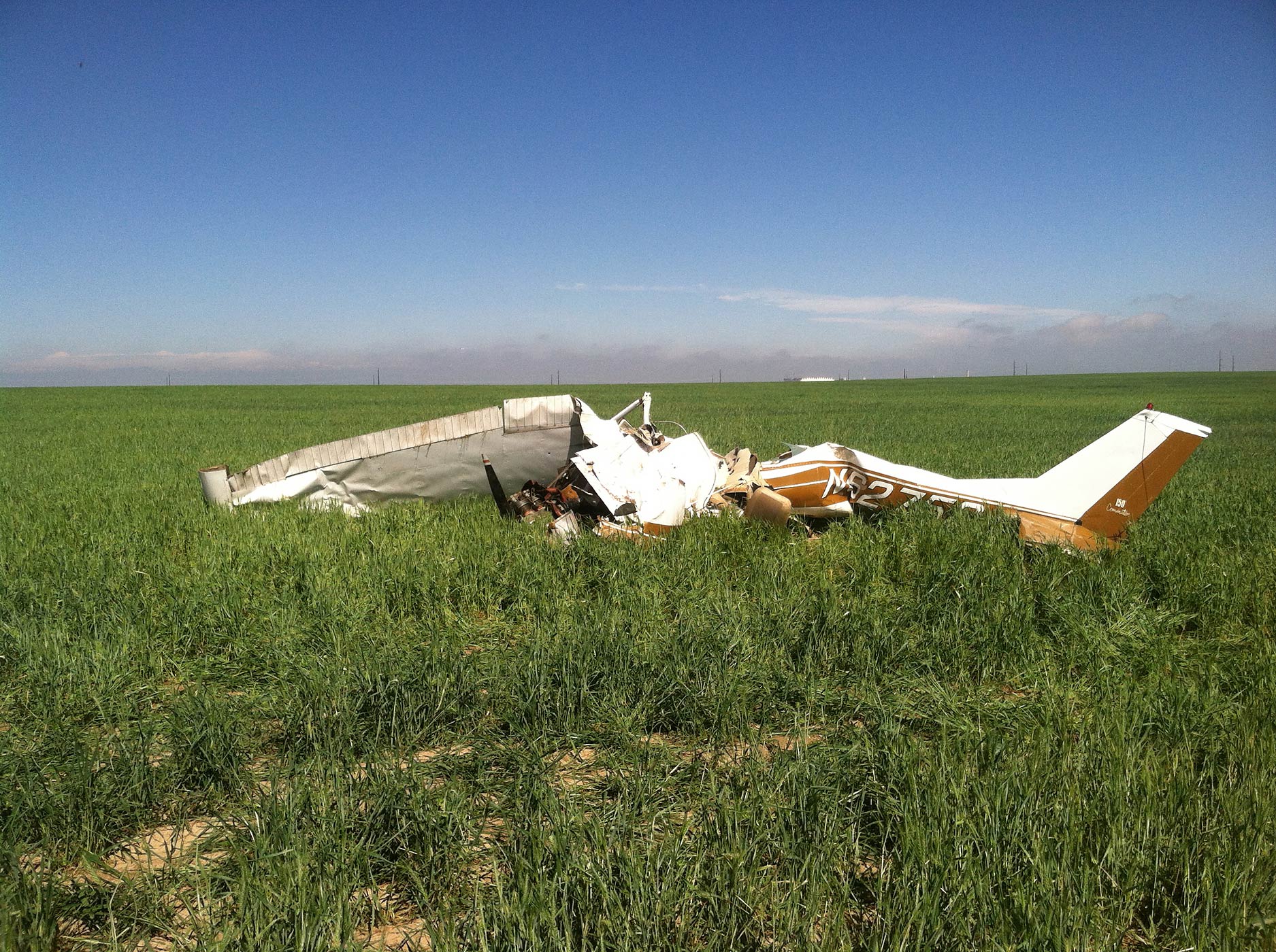 File photo of the wreckage of a crashed Cessna 150 airplane lying in a field near Watkins, Colorado