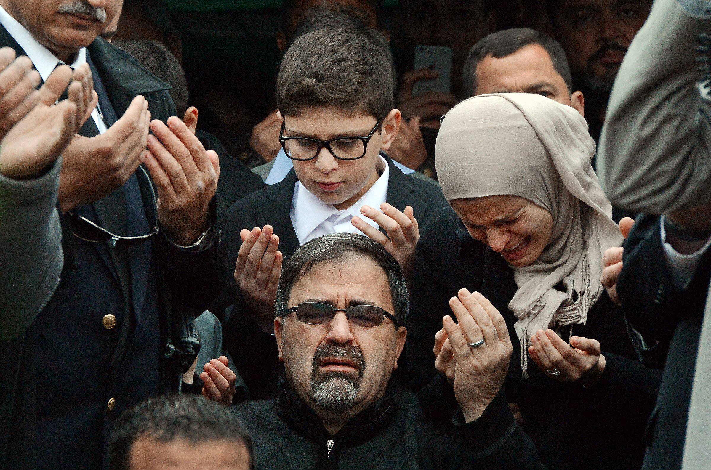 Namee Barakat, center, watches during funeral services for his son, Deah Shaddy Barakat, Feb. 12, 2015, in Wendell, N.C.