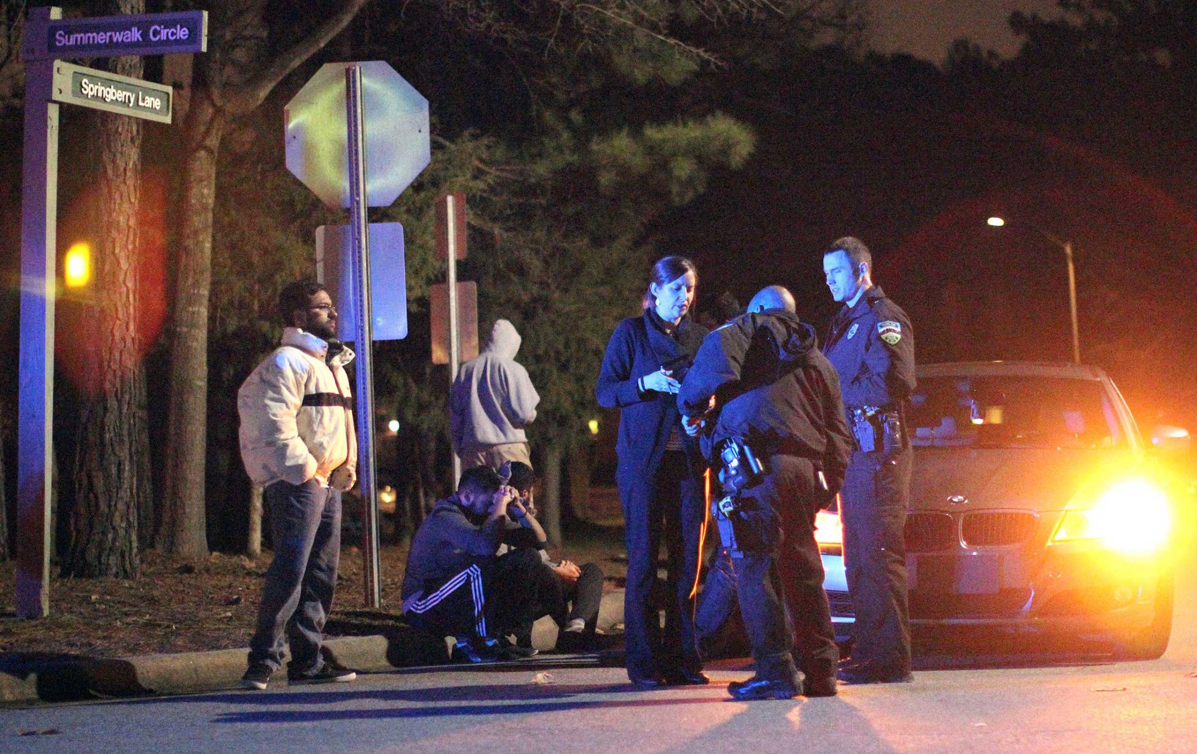 Chapel Hill police officers investigate the scene of three murders near Summerwalk Circle in Chapel Hill, N.C., Feb. 10, 2015.