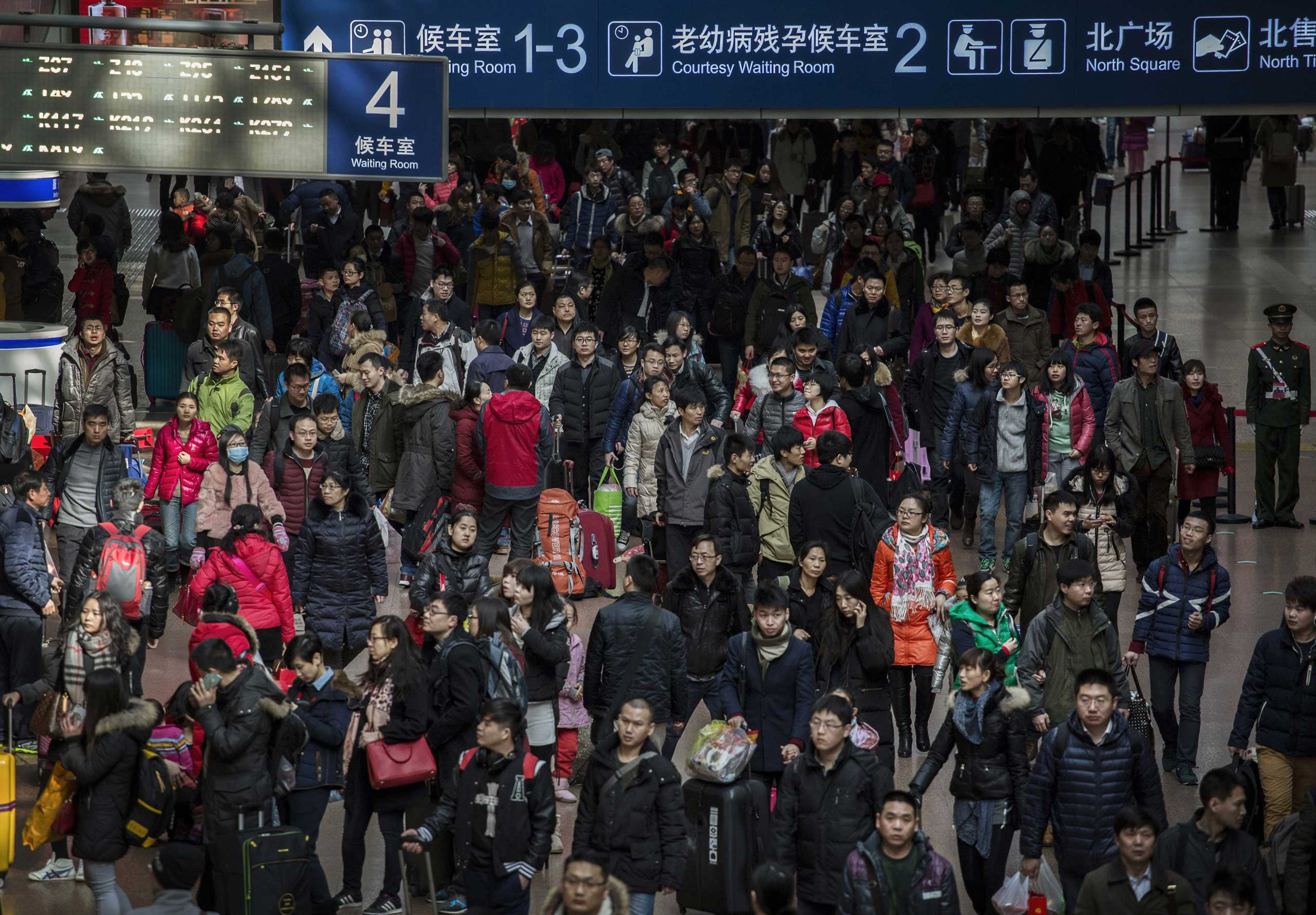 Travelers crowd the station while leaving for the  Spring Festival at a local railway station on Feb. 17, 2015 in Beijing.