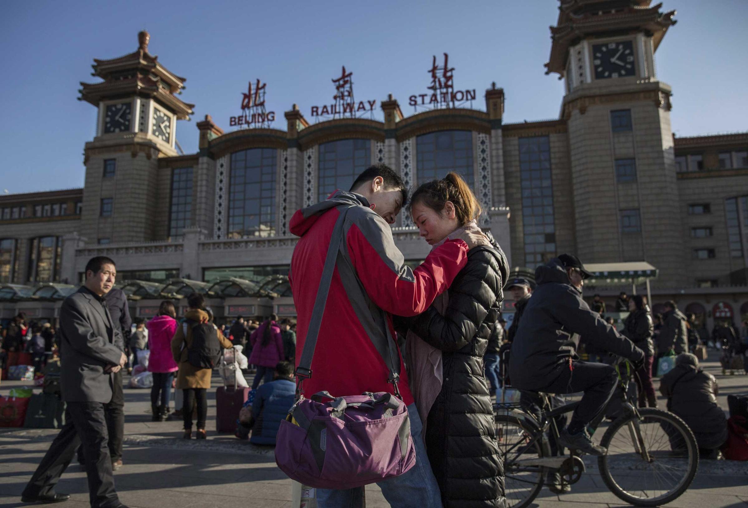A couple says goodbye before leaving to visit their respective families for the Spring Festival at a local railway station on Feb. 17, 2015 in Beijing.