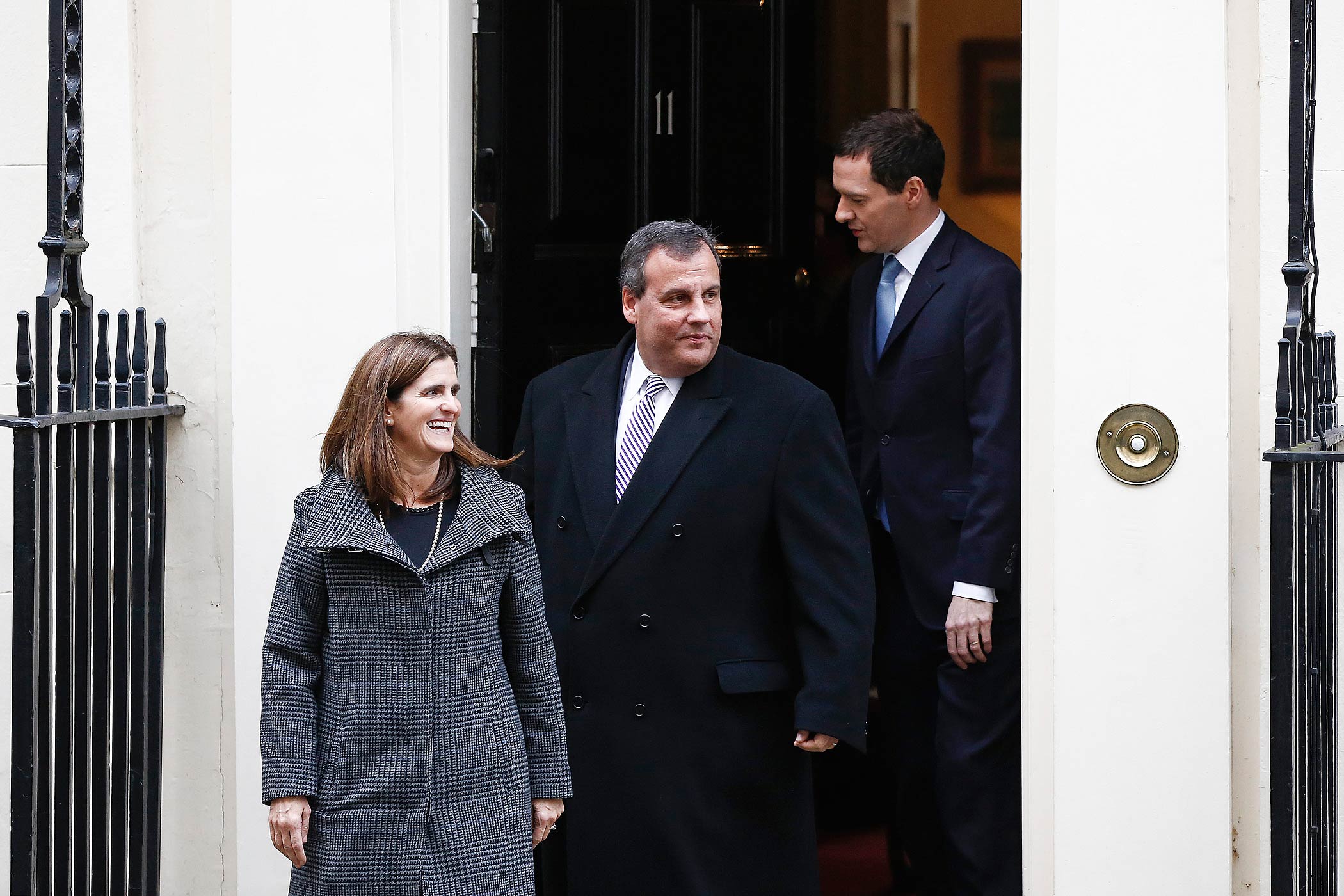 British Chancellor of the Exchequer George Osborne, right, follows Chris Christie, governor of New Jersey, center, and his wife Mary Pat Christie, out of 11 Downing Street following their meeting in London, U.K., on Feb. 3, 2015. (Simon Dawson—Bloomberg/Getty Images)