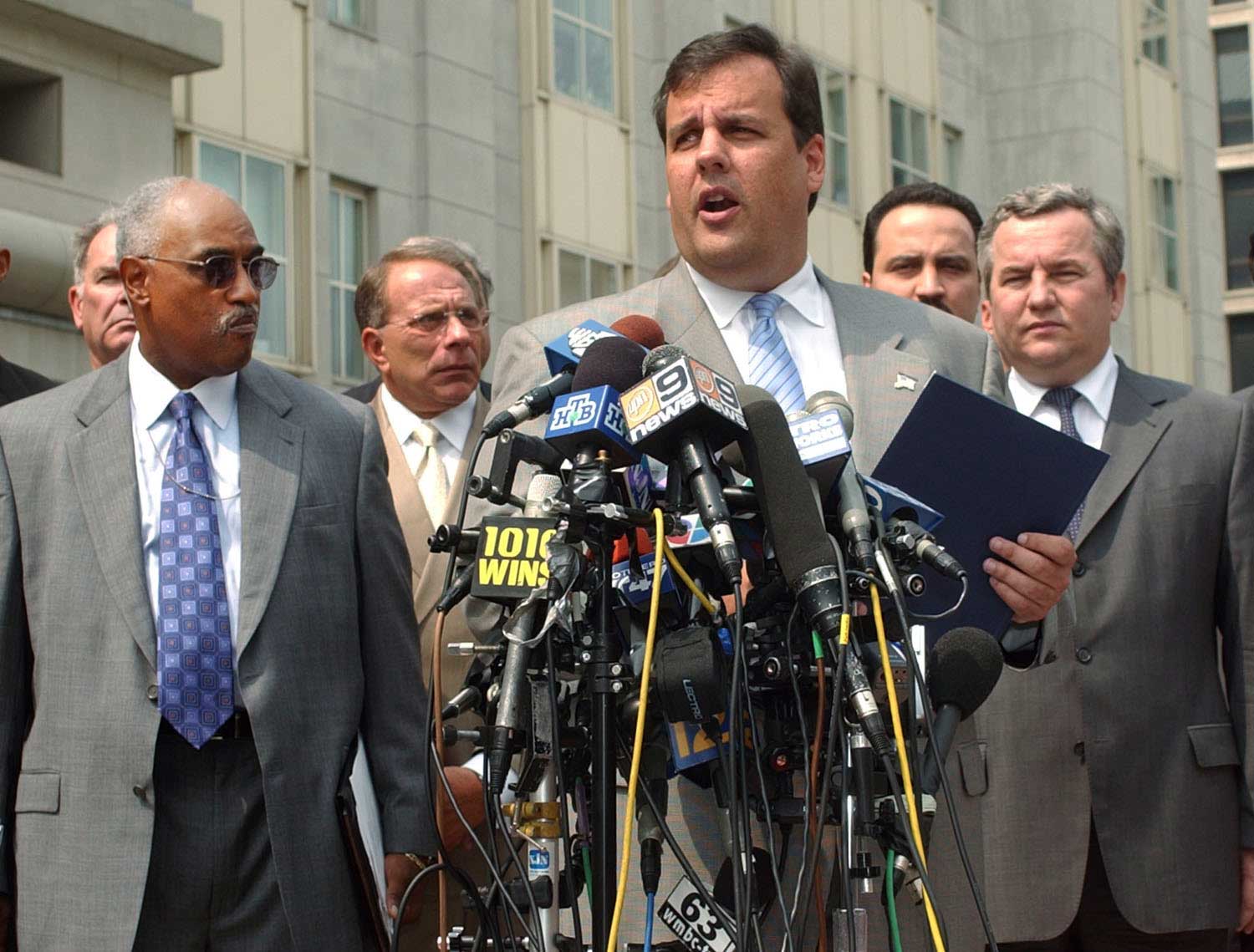 Chris Christie, center, answers a question on the steps of U.S. District Courthouse in Newark, N.J. on Aug. 13, 2003.