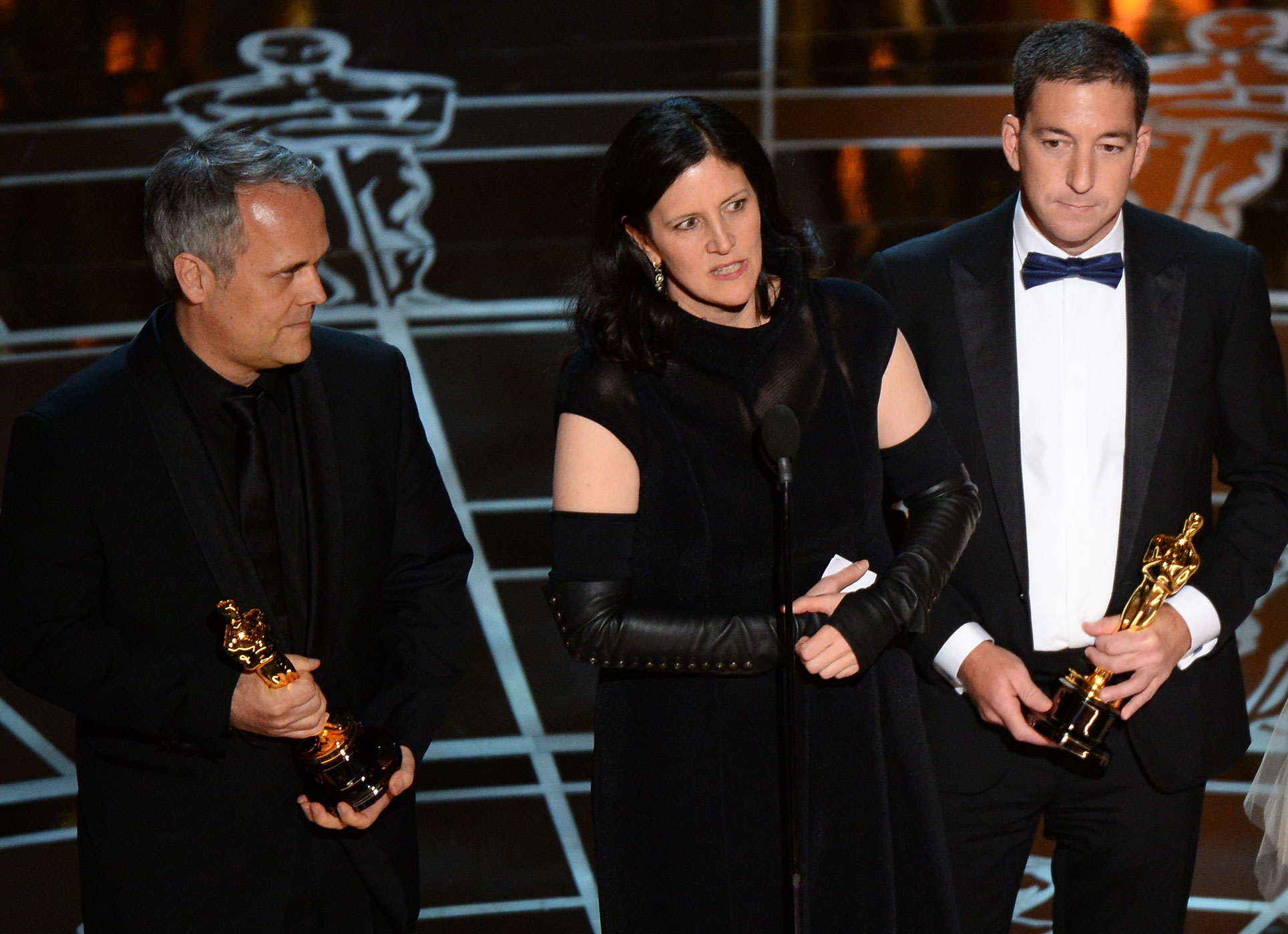 Winners for Best Documentary Feature <i>CitizenFour</i> Laura Poitras, center, and Dirk Wilutzky, left, give their acceptance speech flanked by Glenn Greenwald  at the 87th Oscars Feb. 22, 2015 in Hollywood, Calif. (Robyn Beck—AFP/Getty Images)