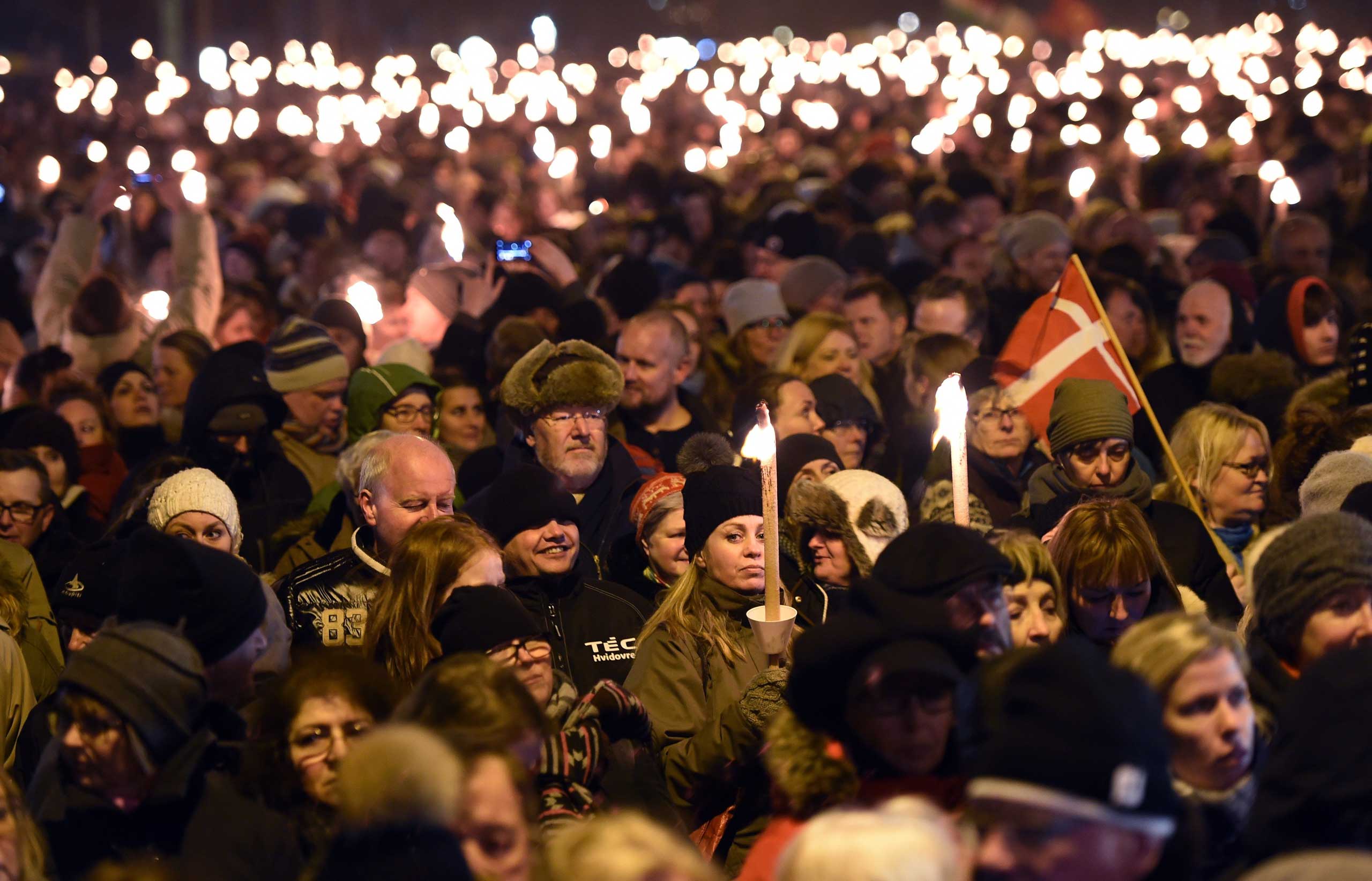 People attend a memorial service held for those killed on by a 22-year-old gunman, in Copenhagen, Denmark, Feb. 16, 2015. (Britta Pedersen—dpa/Corbis)