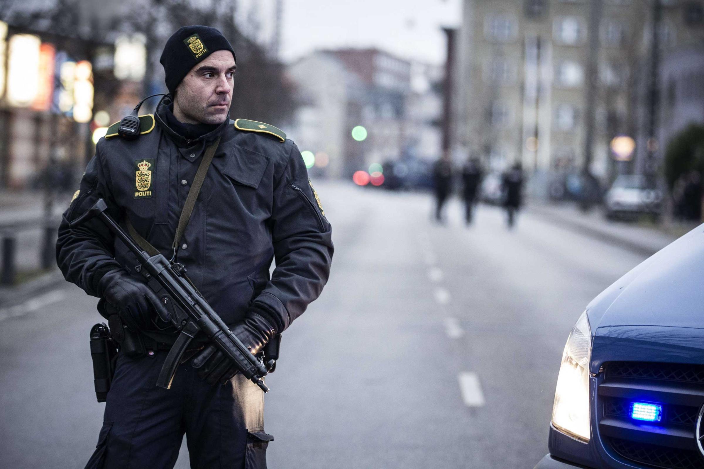 A police officer guards the street around the Noerrebro train station in Copenhagen on Feb. 15, 2015 where a man has been shot in a police action following two fatal attacks in the Danish capital.