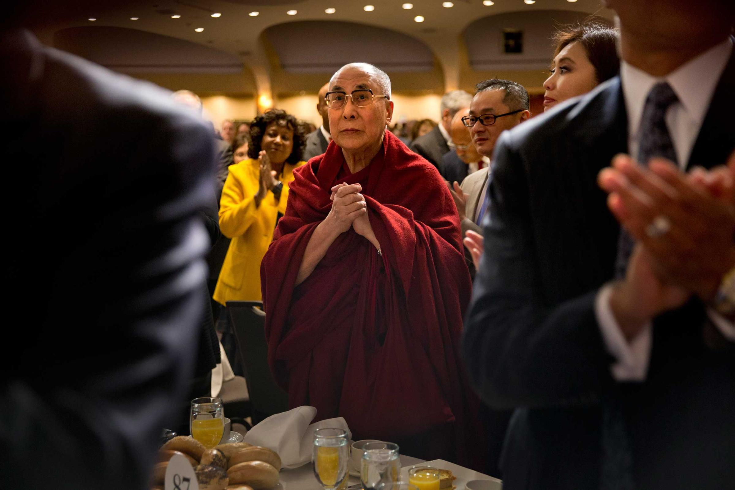 The Dalai Lama stands at the National Prayer Breakfast in Washington, Feb. 2015.