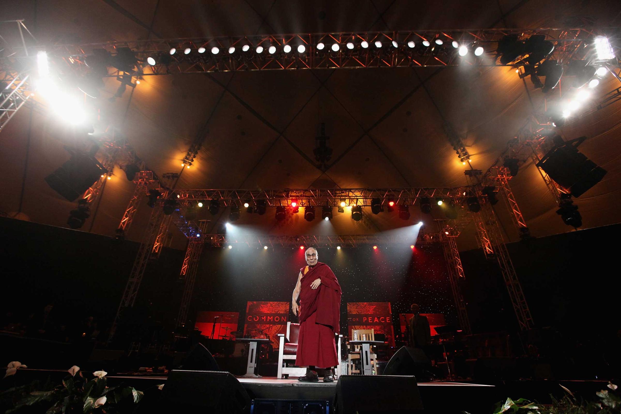 His Holiness the Dalai Lama speaks onstage at the One World Concert at Syracuse University in Syracuse, New York, Oct. 2012.