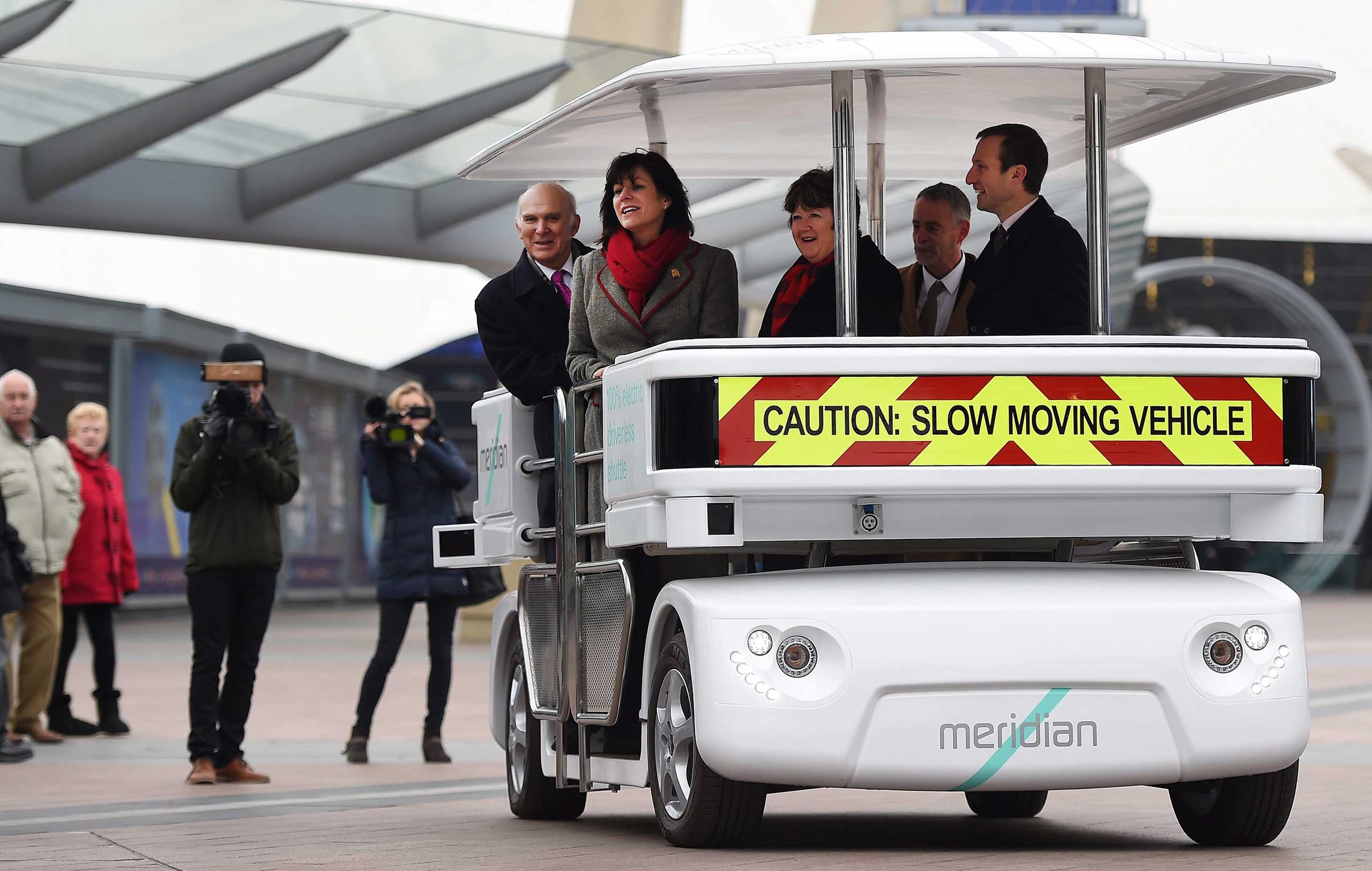 British Transport Minister Claire Perry and British Secretary of State for Business Innovation and Skills Vince Cable ride a driverless 'Meridian' vehicle in London, Feb. 11,2015. (Andy Rain—EPA)