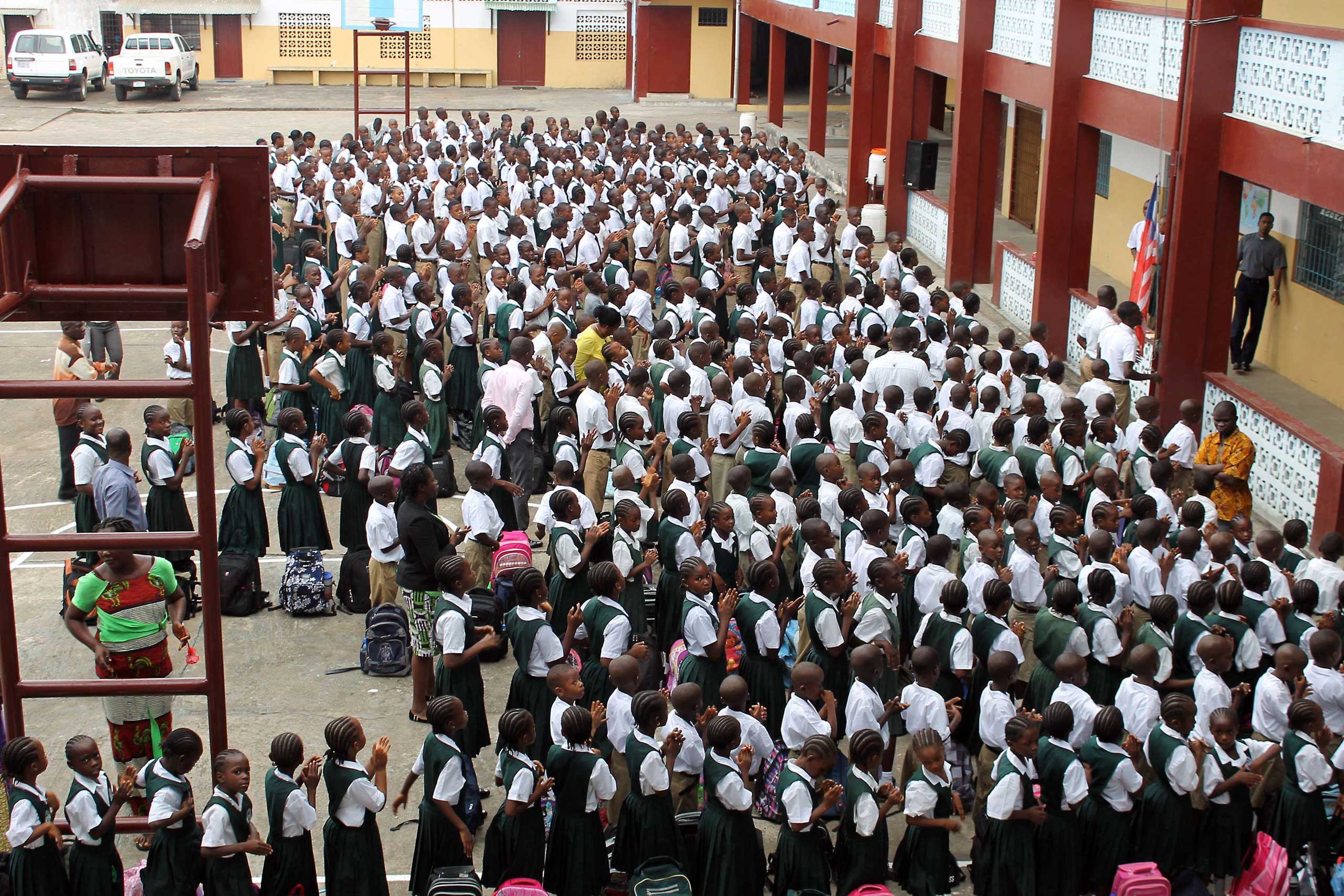 Students stand in line before heading to their classrooms at Don Bosco High School in the Liberian capital, Monrovia, on Feb. 16, 2015 (Zoom Dosso—AFP/Getty Images)