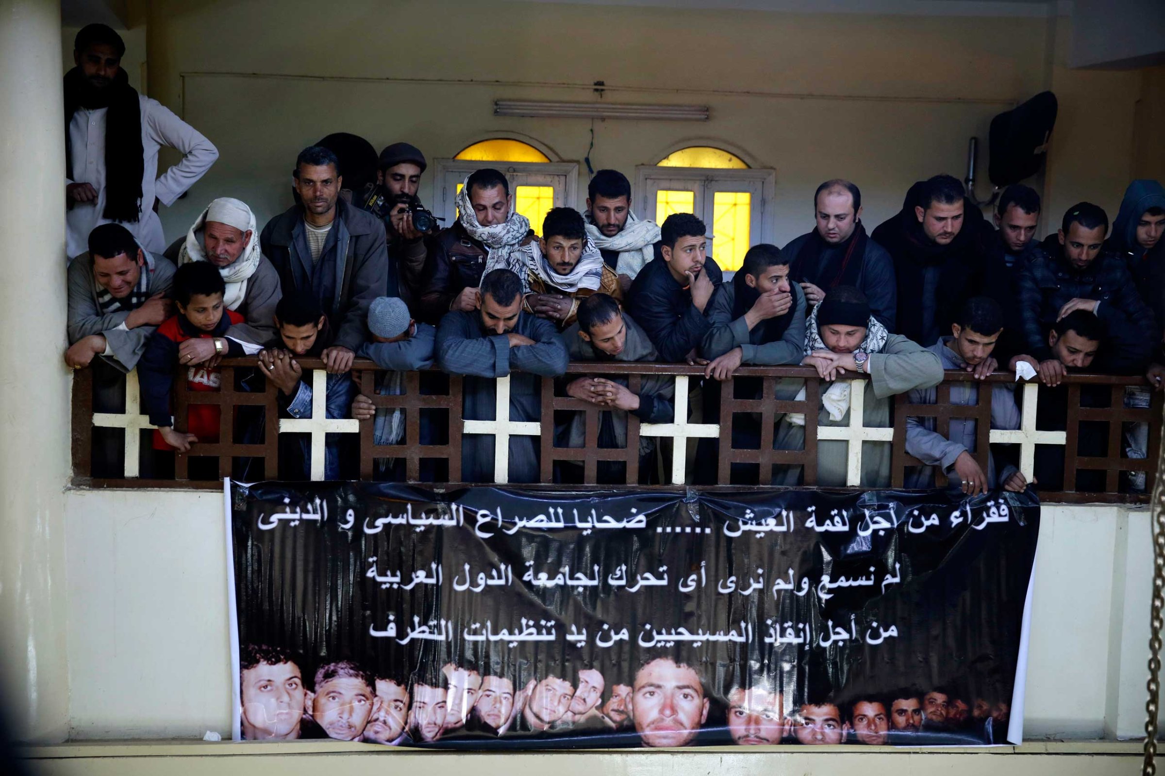 Men mourn over Egyptian Coptic Christians who were captured in Libya and killed by militants affiliated with ISIS, inside the Virgin Mary Church in the village of Al-Aour, Egypt, Feb. 16, 2015.