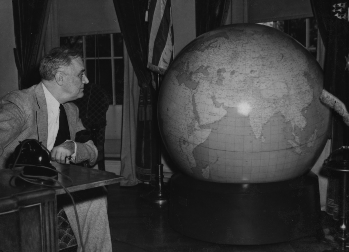 President Franklin Delano Roosevelt inspecting a globe, circa 1942 (Hulton Archive / Getty Images)