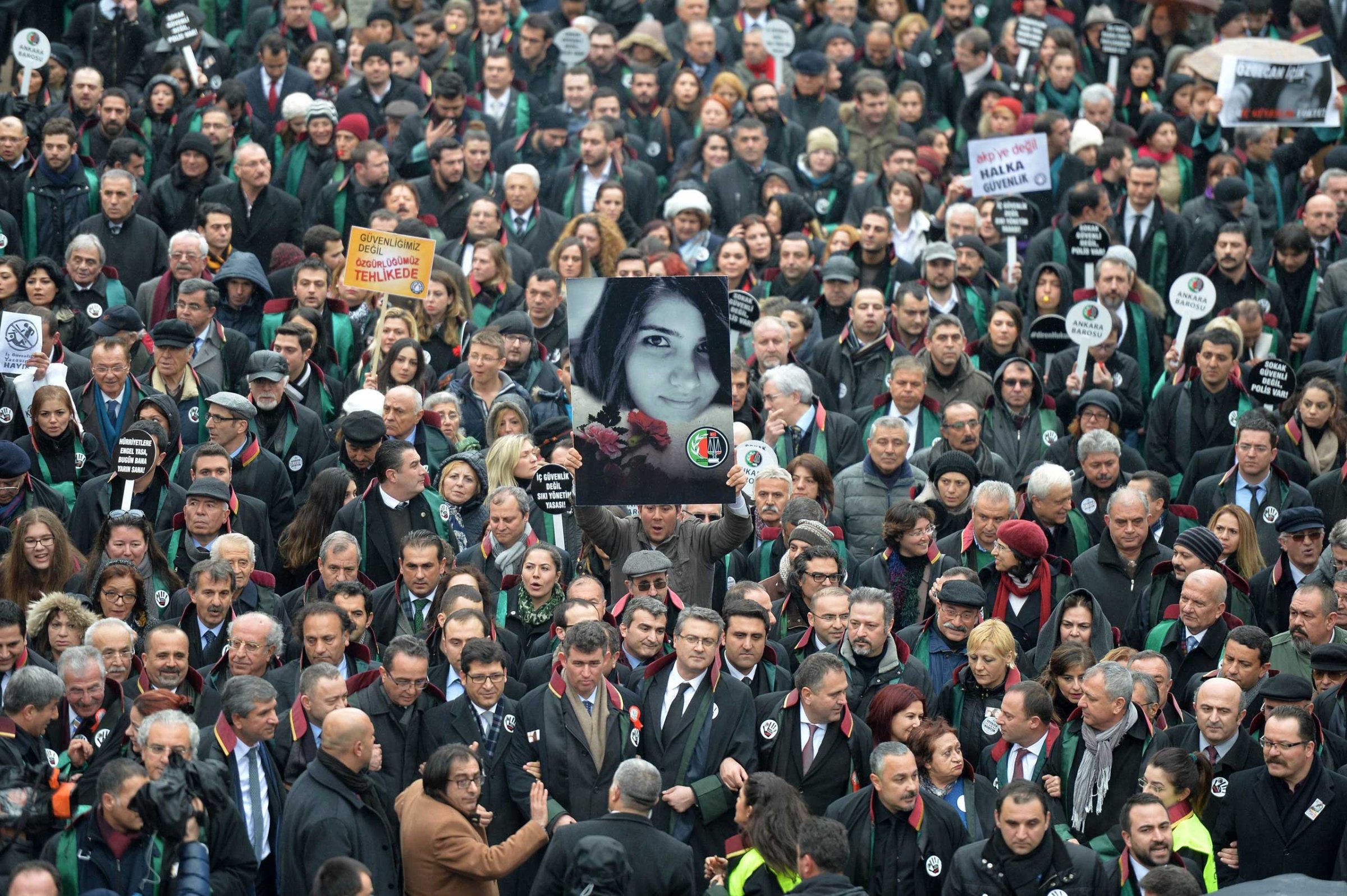A man holds a poster depicting slain Ozgecan Aslan during a march of members of Turkey's Bar Association in Ankara, on Feb. 16, 2015 to protest against a law that strengthens the police's power.