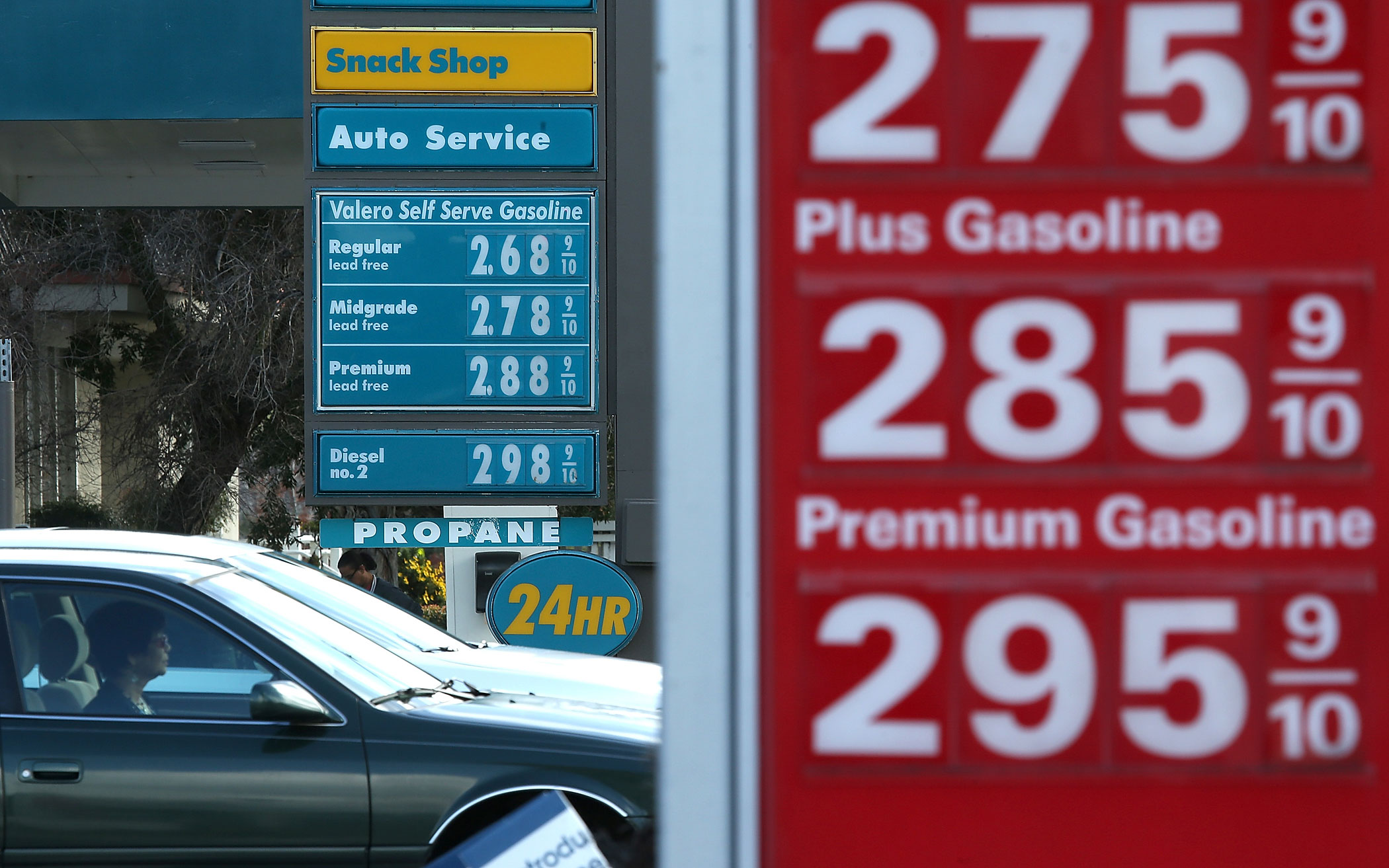 Drivers pass by gas prices that are displayed at Valero and 76 gas stations on Feb. 9, 2015 in San Rafael, Calif. (Justin Sullivan—Getty Images)
