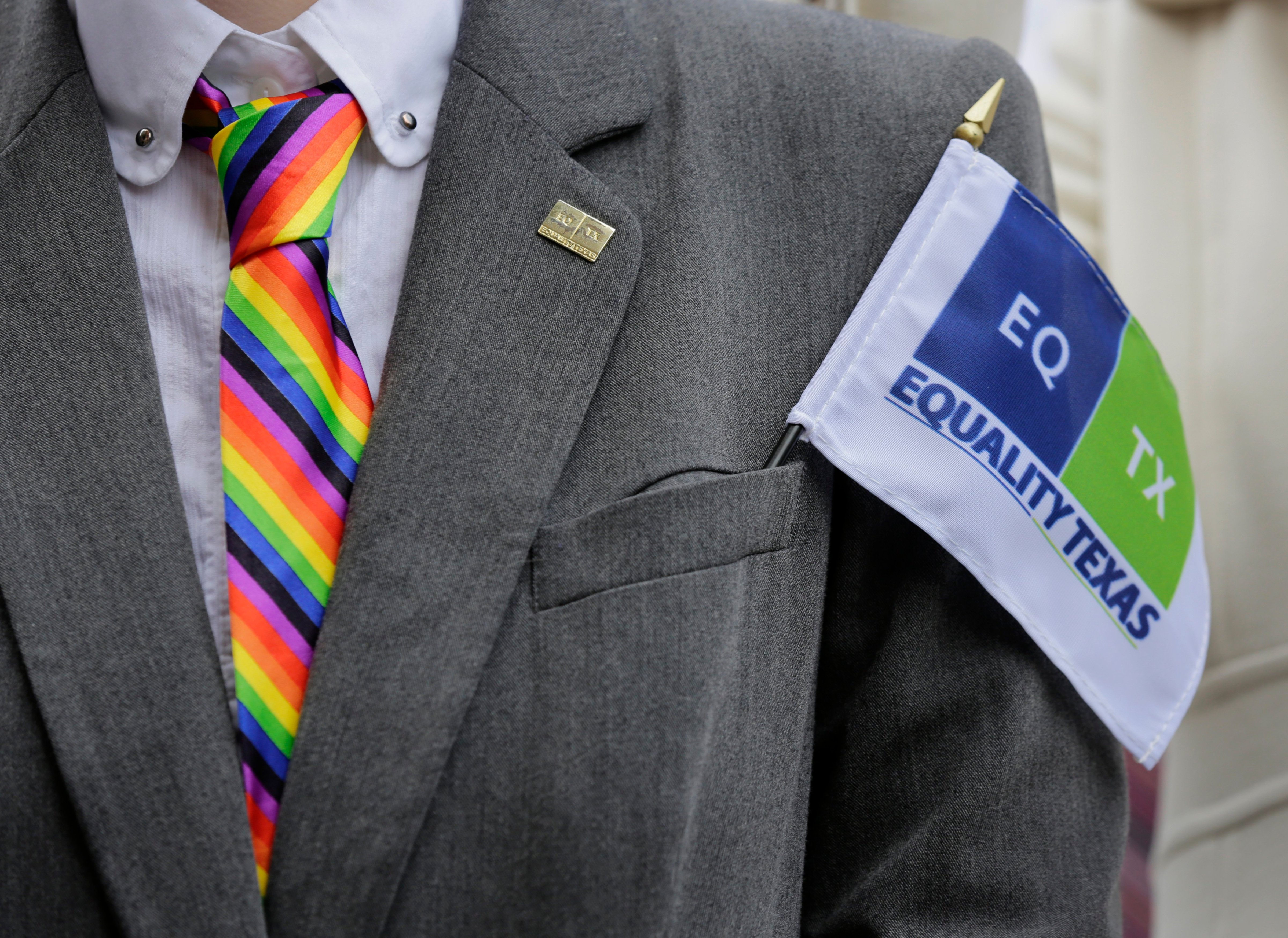 A man wearing a rainbow-colored tie and Equality Texas flag rallies on the steps of the Texas Capitol to call for more equality for same-sex couples on Feb. 17, 2015, in Austin, Texas. (Eric Gay—AP)
